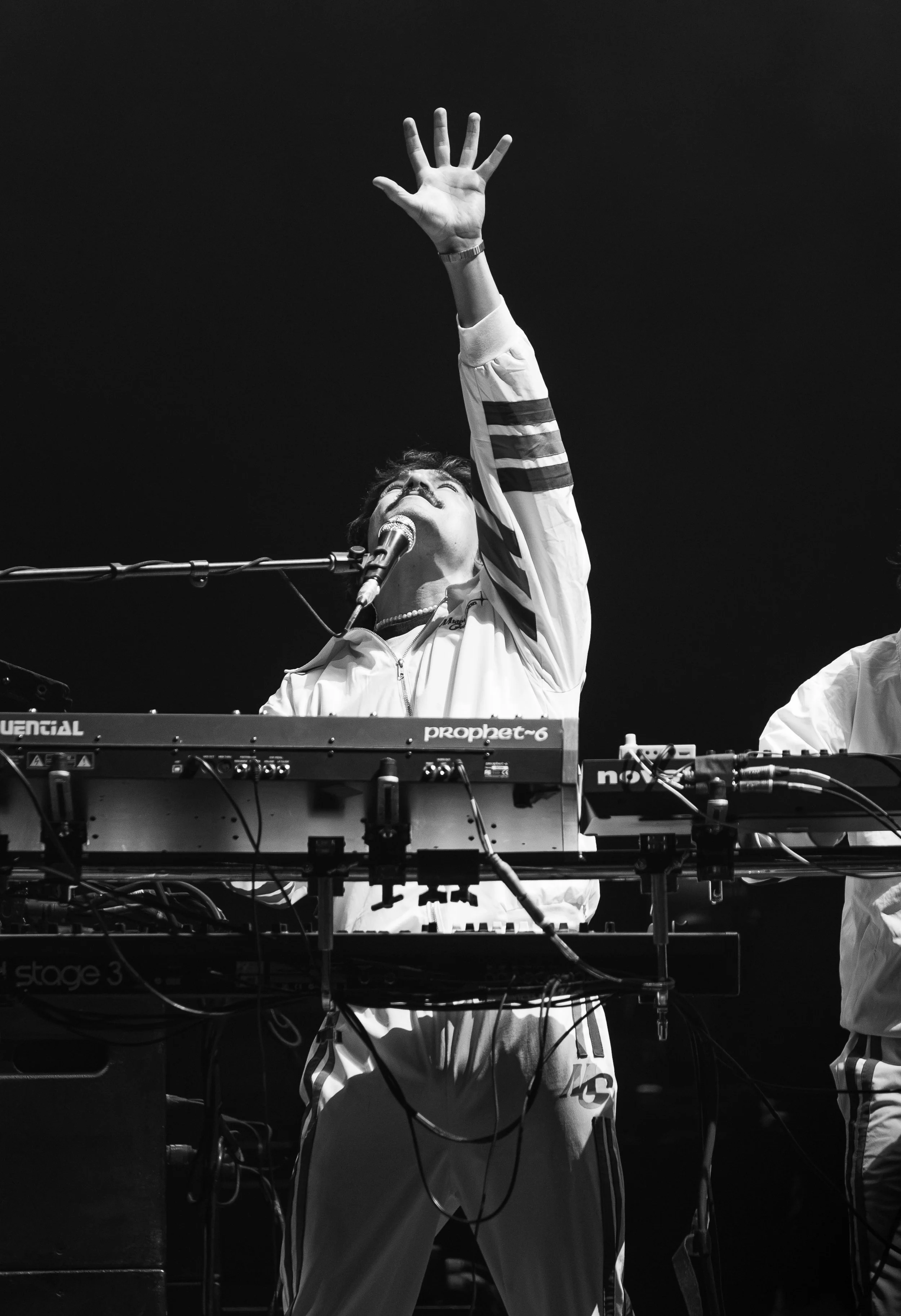 Keyboardist Carlos Amaya of Midnight Generation holds his hand up during “Oh Baby What Comes Around Goes Back Around” off the band’s latest album  Tender Love.  