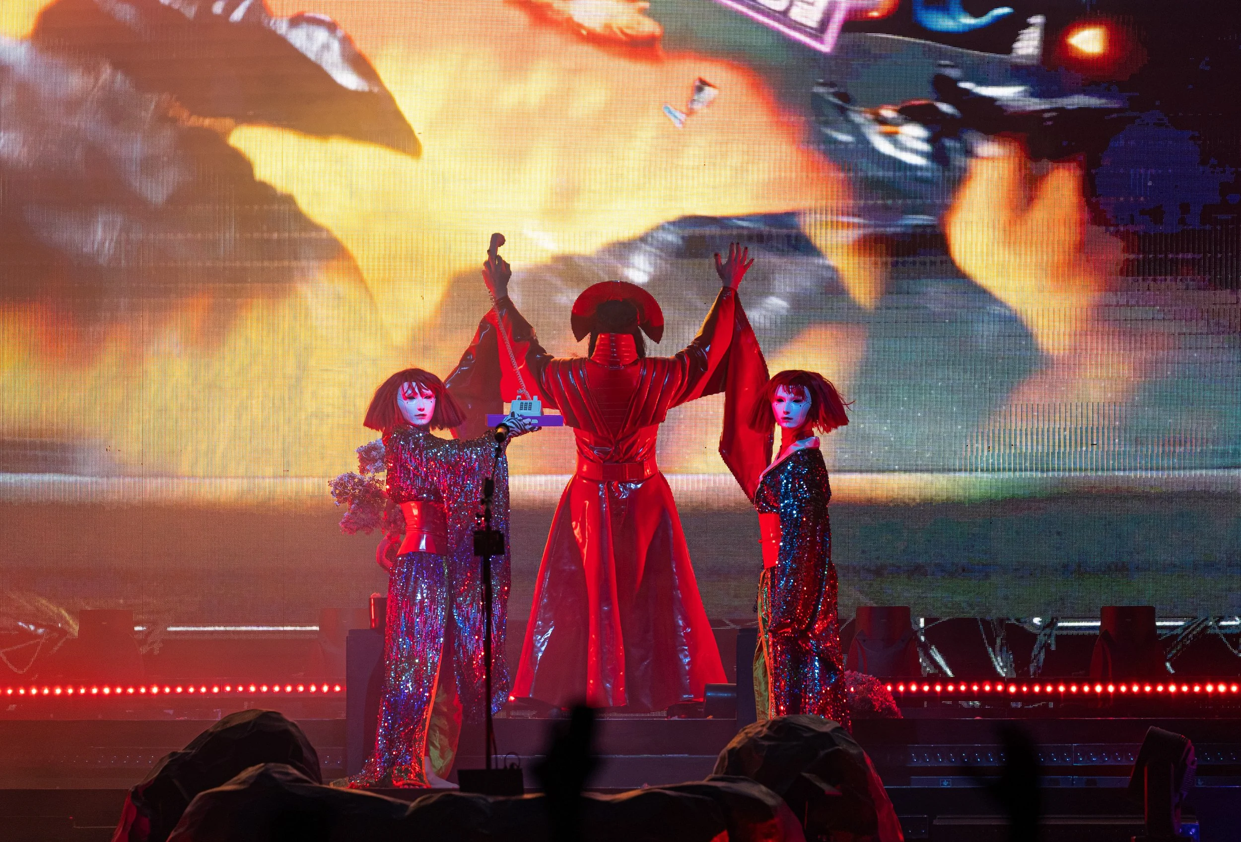  Steele holds up a phone during the Afterlife Insurance transition, a reference to the fourth song on  Ask That God , as the track for “Cherry Blossom” starts playing. 