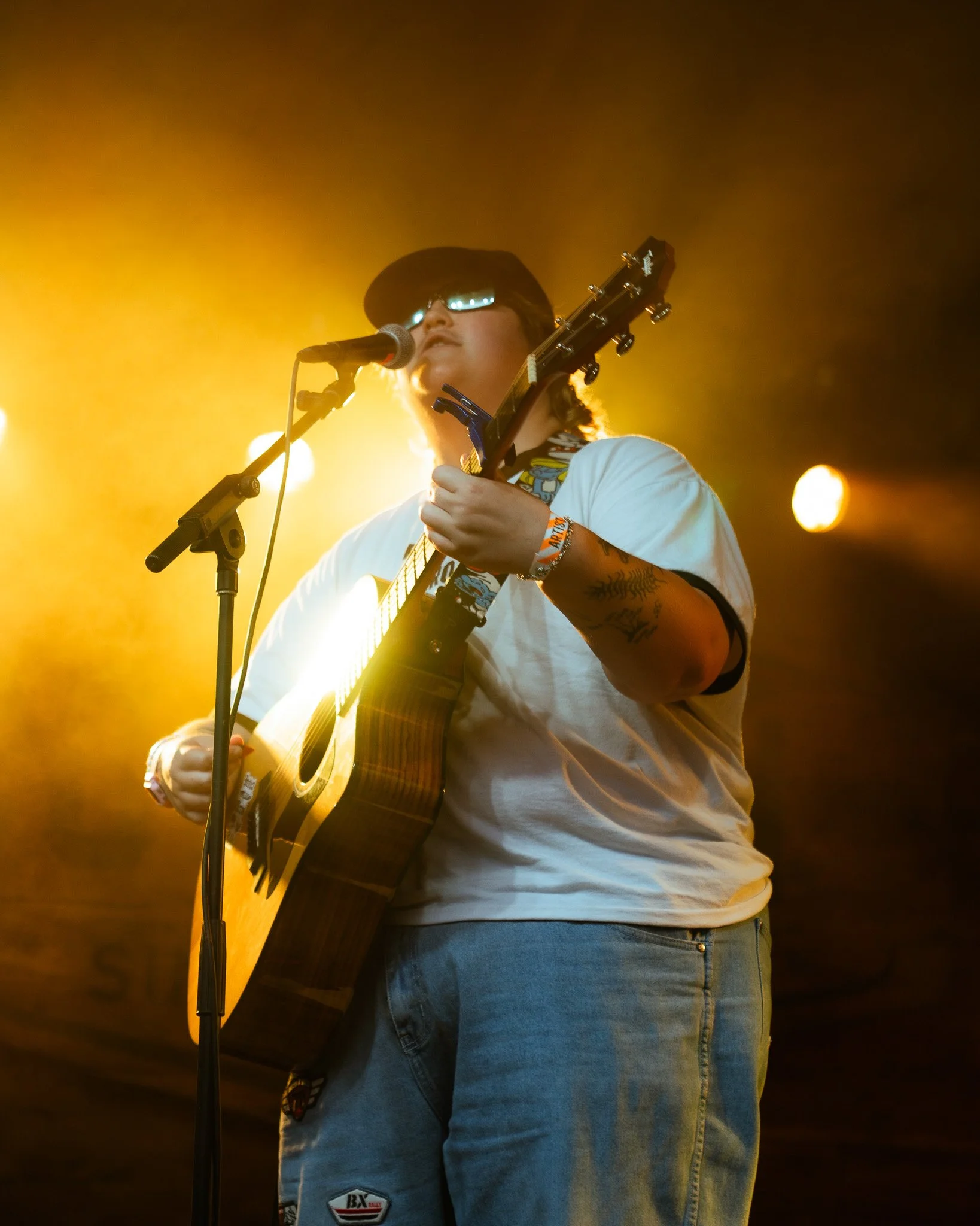  Bright yellow lights glow as hey, nothing starts its set with an acoustic version of “Hound.” 