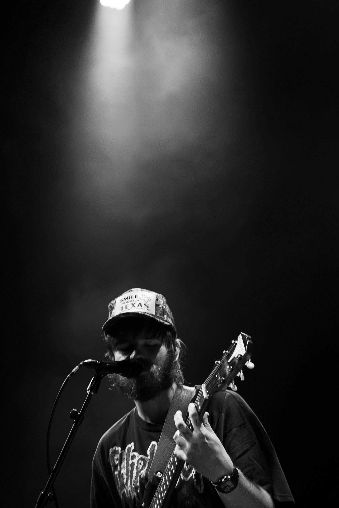  Nate Amos, also known as This Is Lorelei, plays guitar under a single spotlight while performing "I Will Eat My Heart in the Morning Light" from The Singer in My Band . 