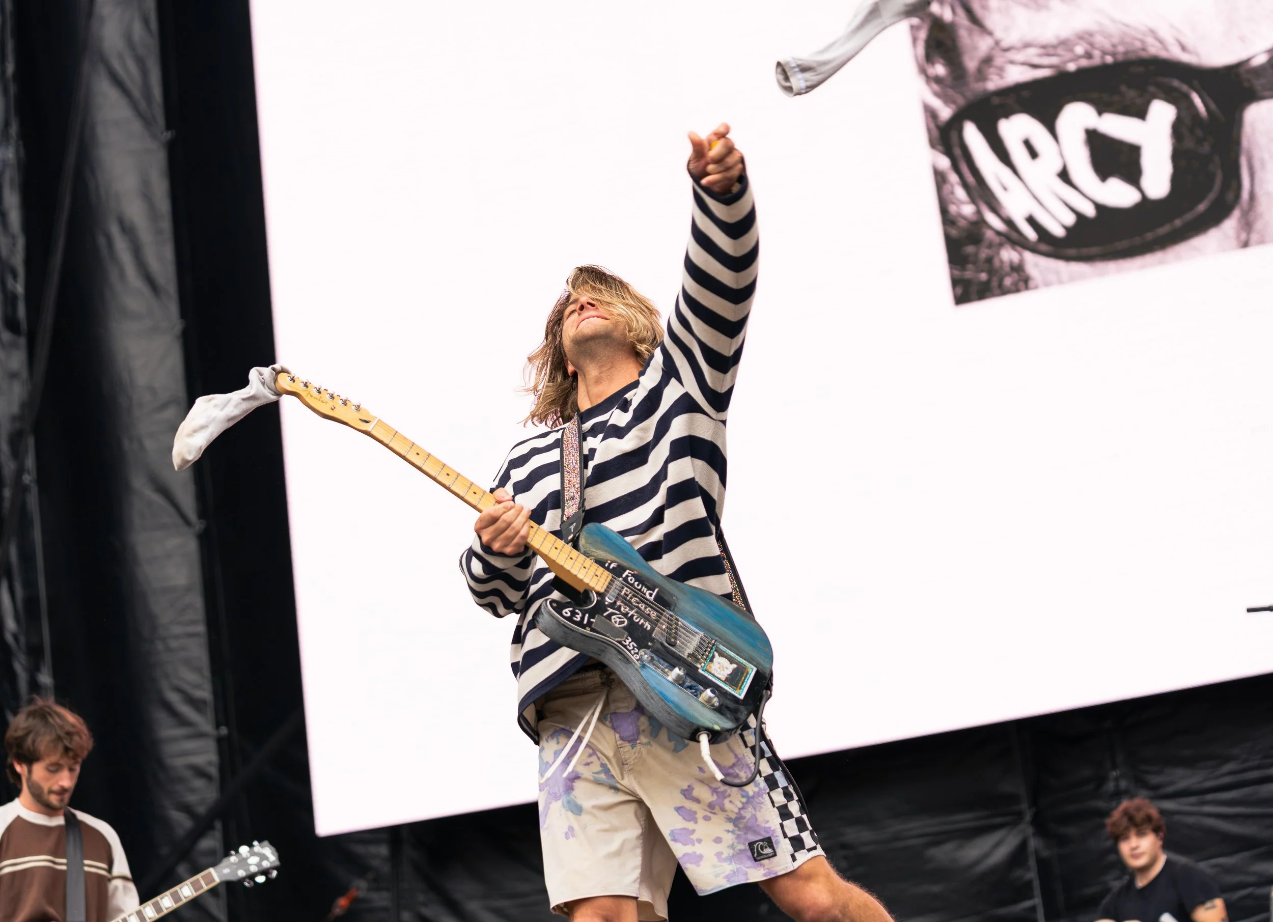  Arcy Drive lead vocalist and rhythm guitarist Nick Mateyunas throws a sock to the crowd as the band begins “Under the Rug.” 