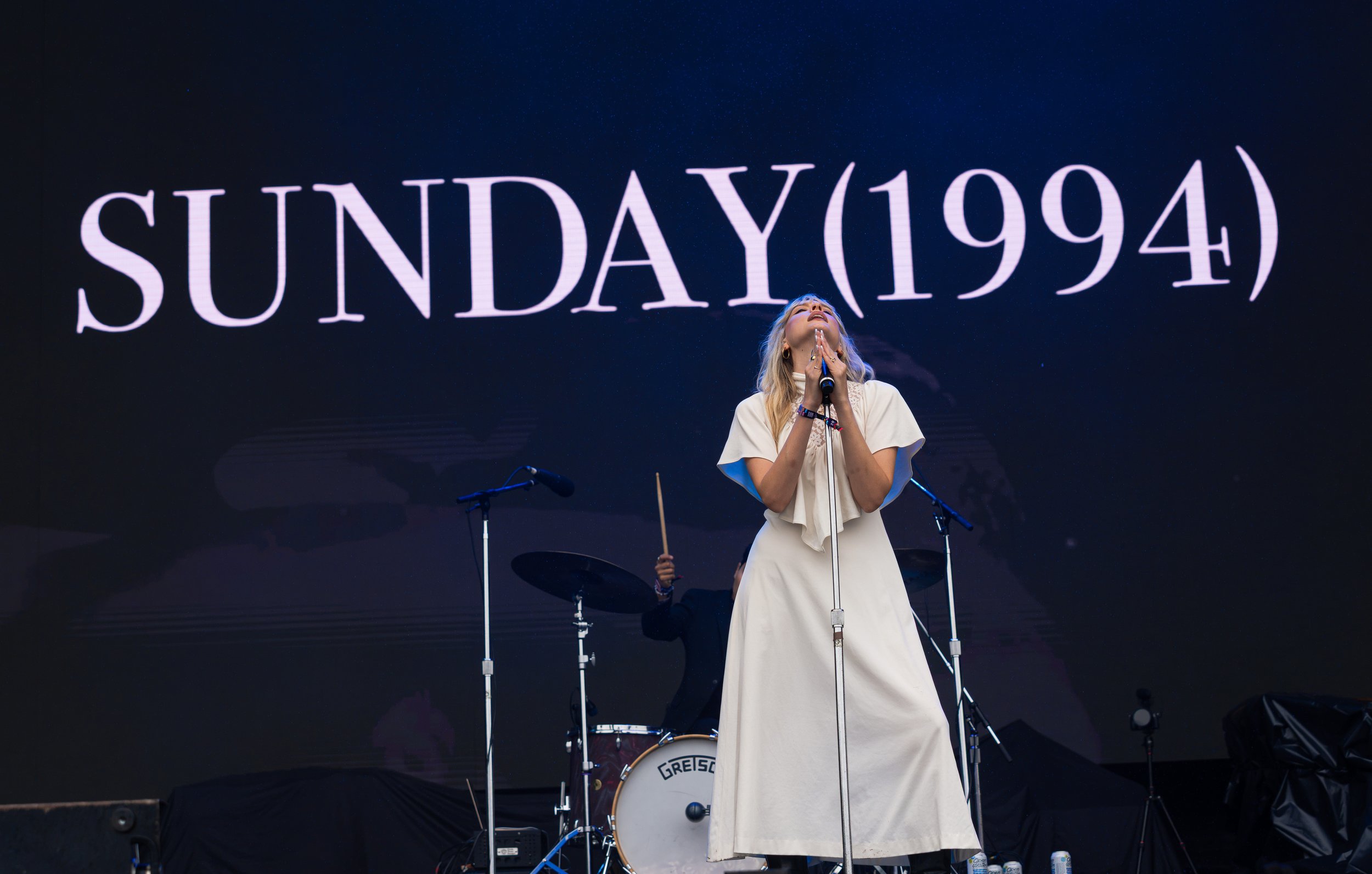  As rain hits the stage, Sunday (1994) lead singer Paige Turner sings the longing lyrics of “Rain”: “If I don't have you, then I've got nothing to lose, it's true / Did it even happen if you didn't see it too? / Now, the rain starts to fall.” 
