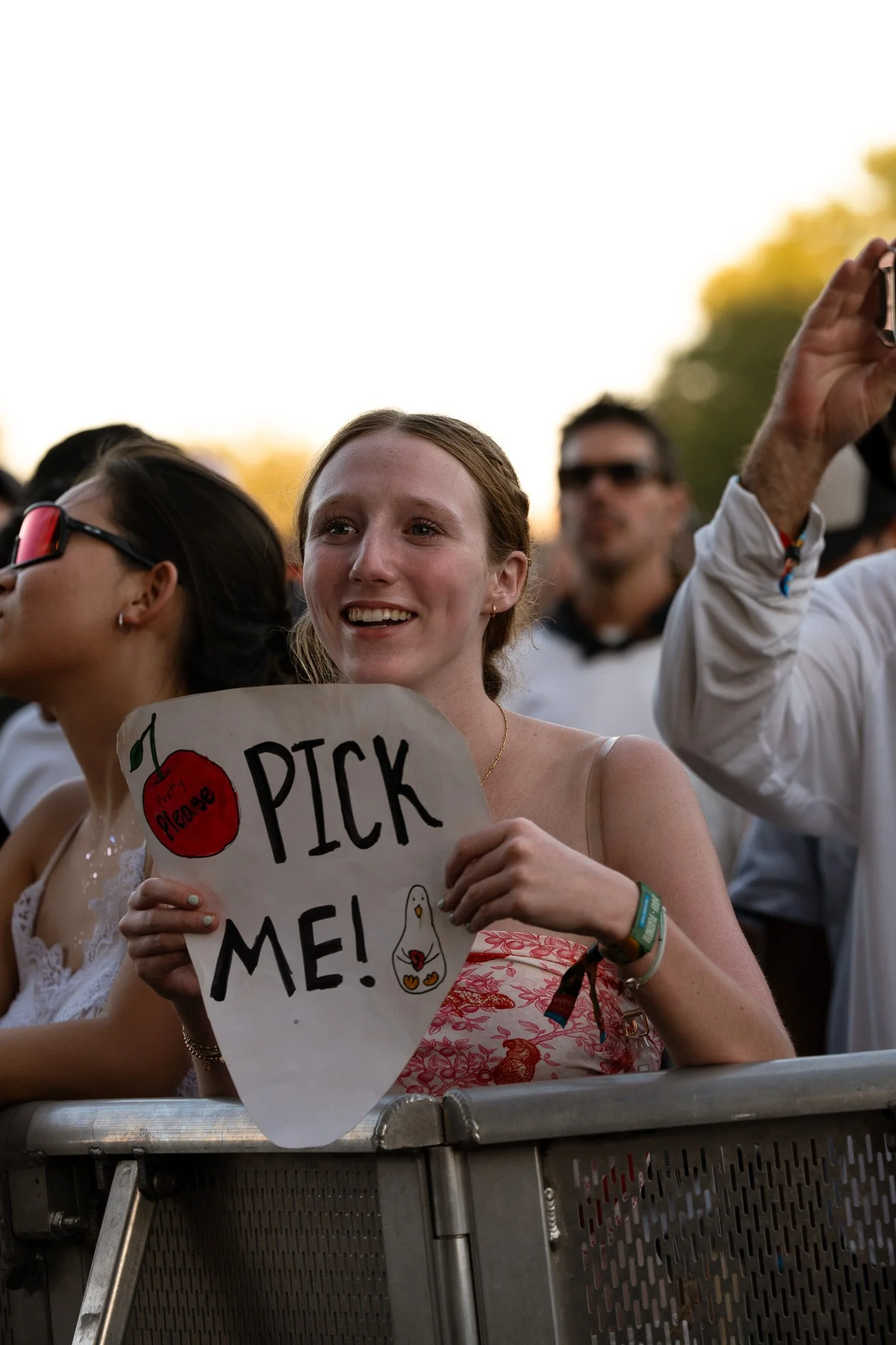  A Geese fan holds up a “Pick Me” sign on the barricade during “Husbands.” 
