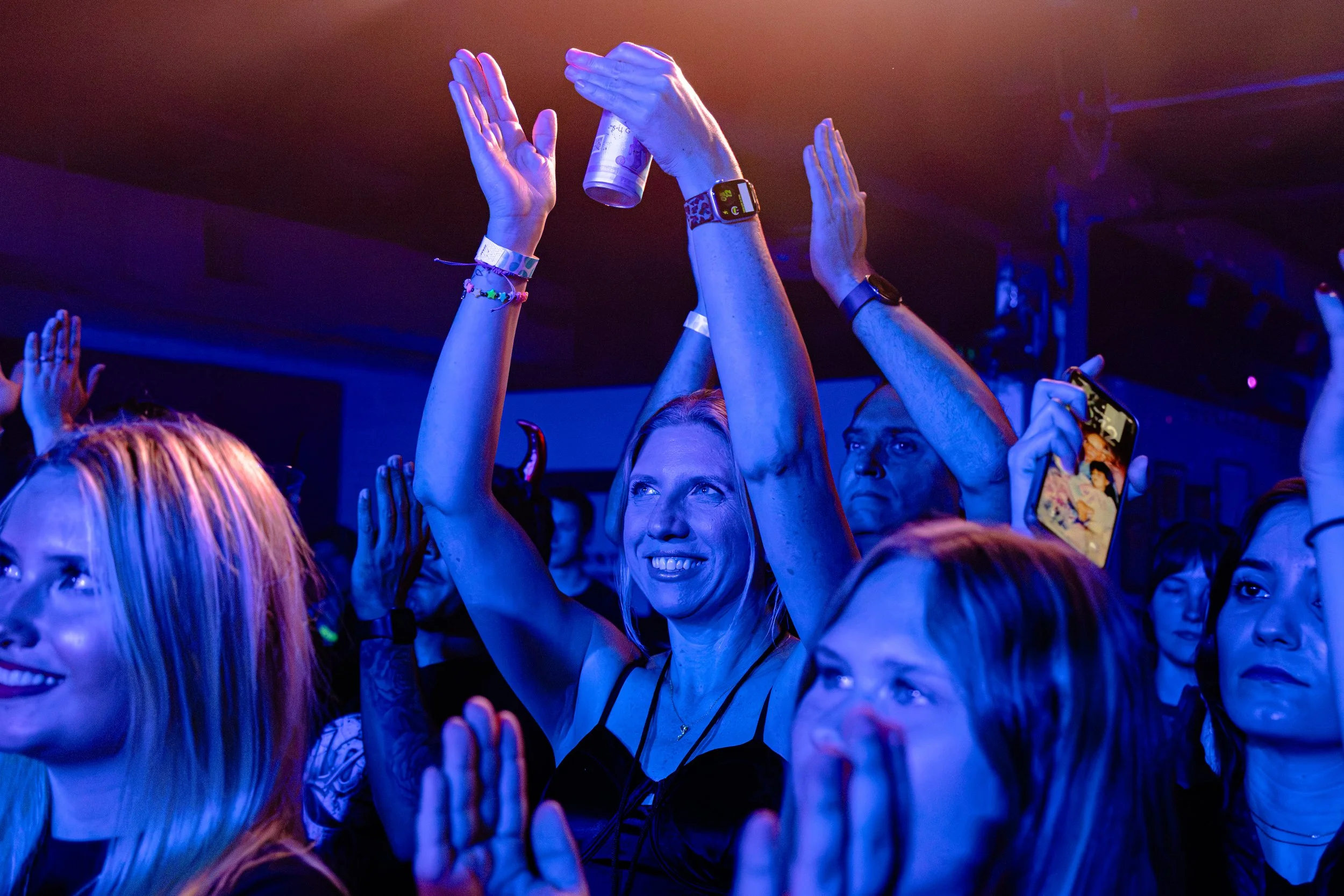  Fans raise their hands and clap as Taylor performs “girls and drugs” from her debut album  parasite.  