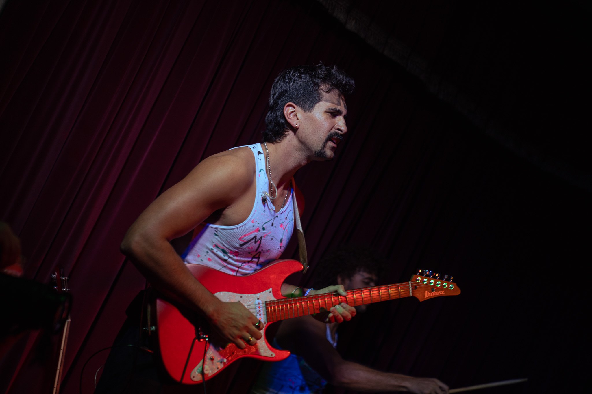  Guitarist Andrew Lucas intricately plays the chords of “Body Is On Fire.” 