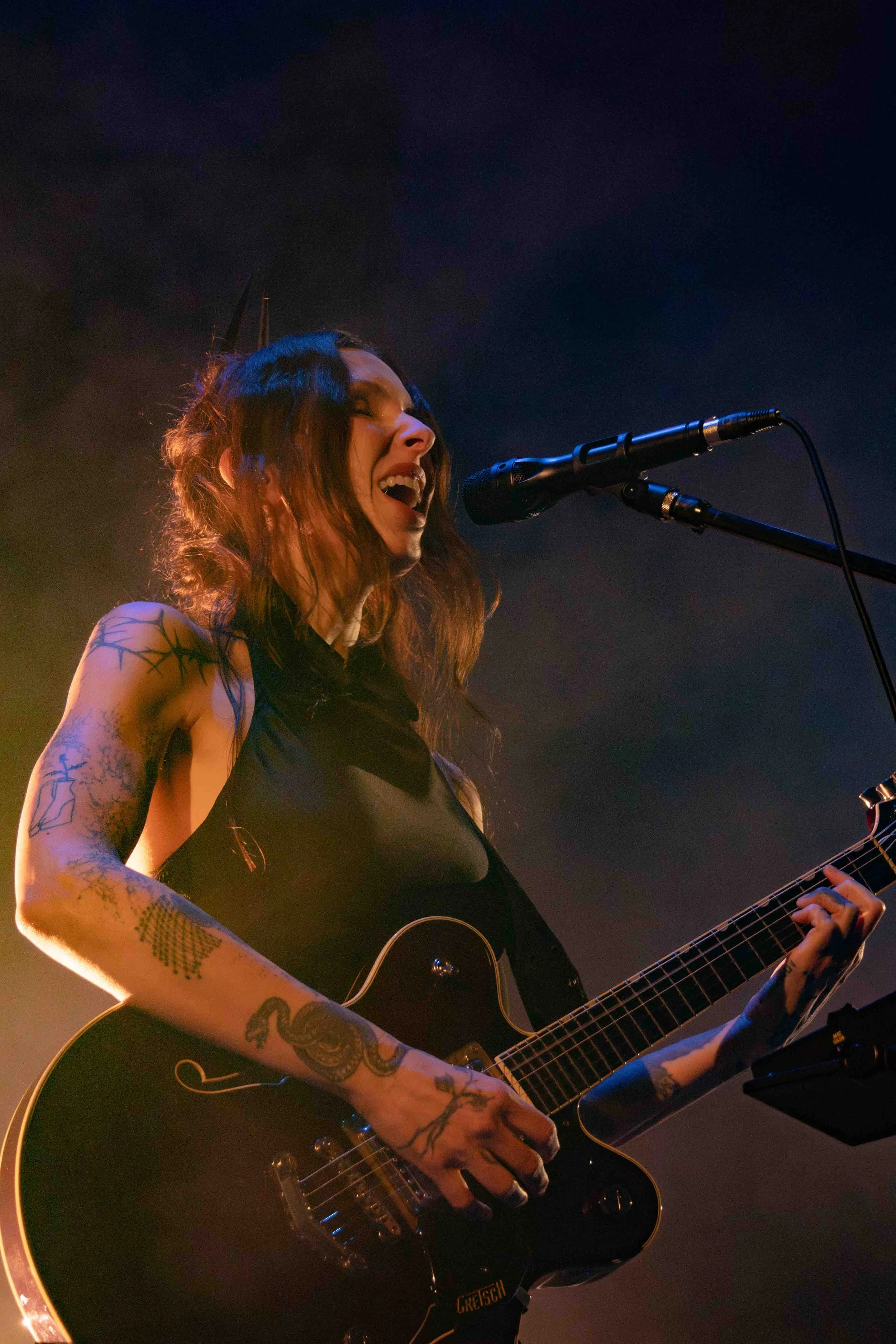  Wolfe performs her crushing song “Iron Moon” with an electric guitar.&nbsp; 