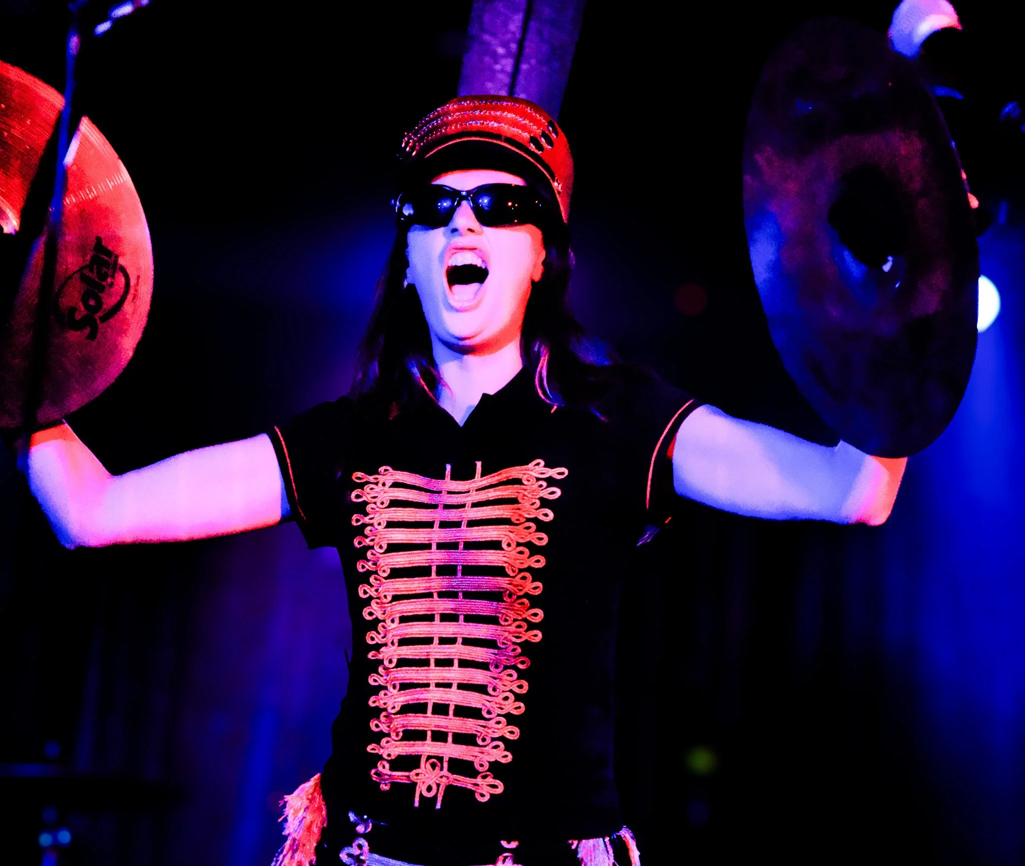  Dev Lemons enters the ballroom with cymbals as fans scream in support. 
