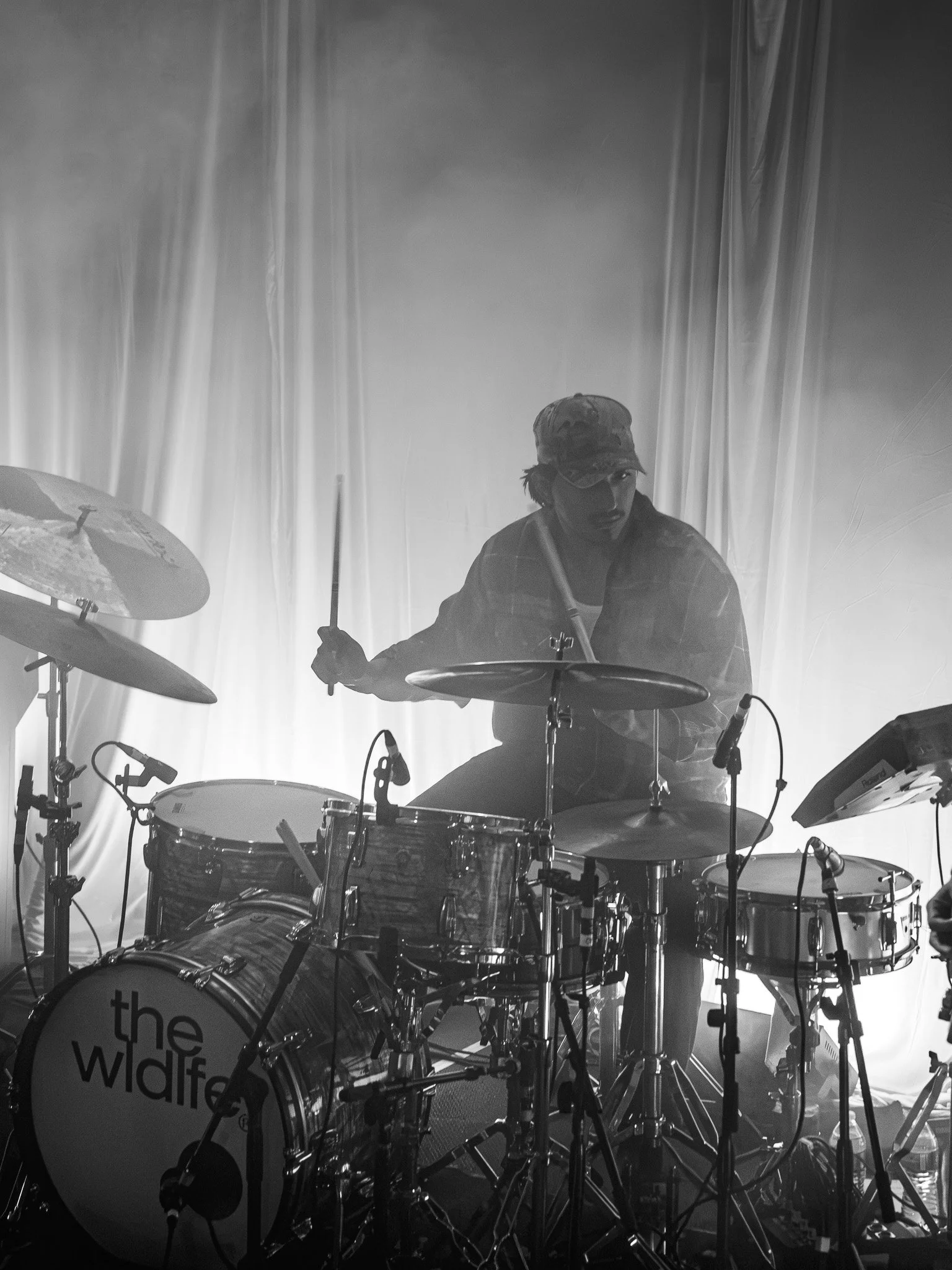  Drummer Miles Laderman plays amidst fog during the performance of “No Sleep.” 