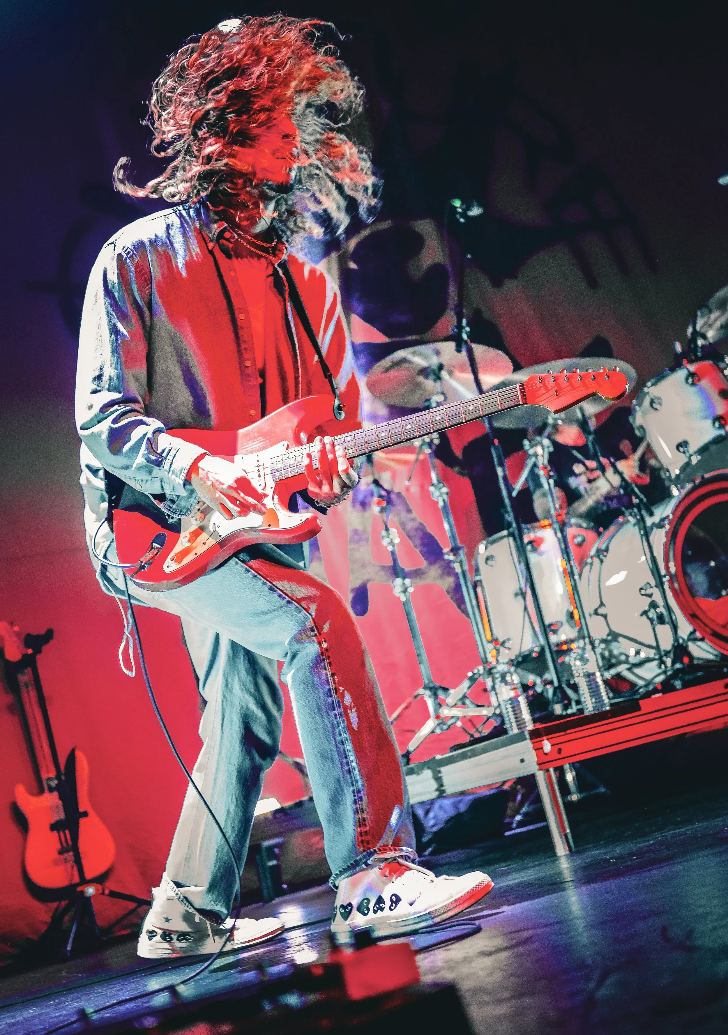  Contreras strums his guitar and flips his hair around as he energetically performs the upbeat song “Heaven.” 