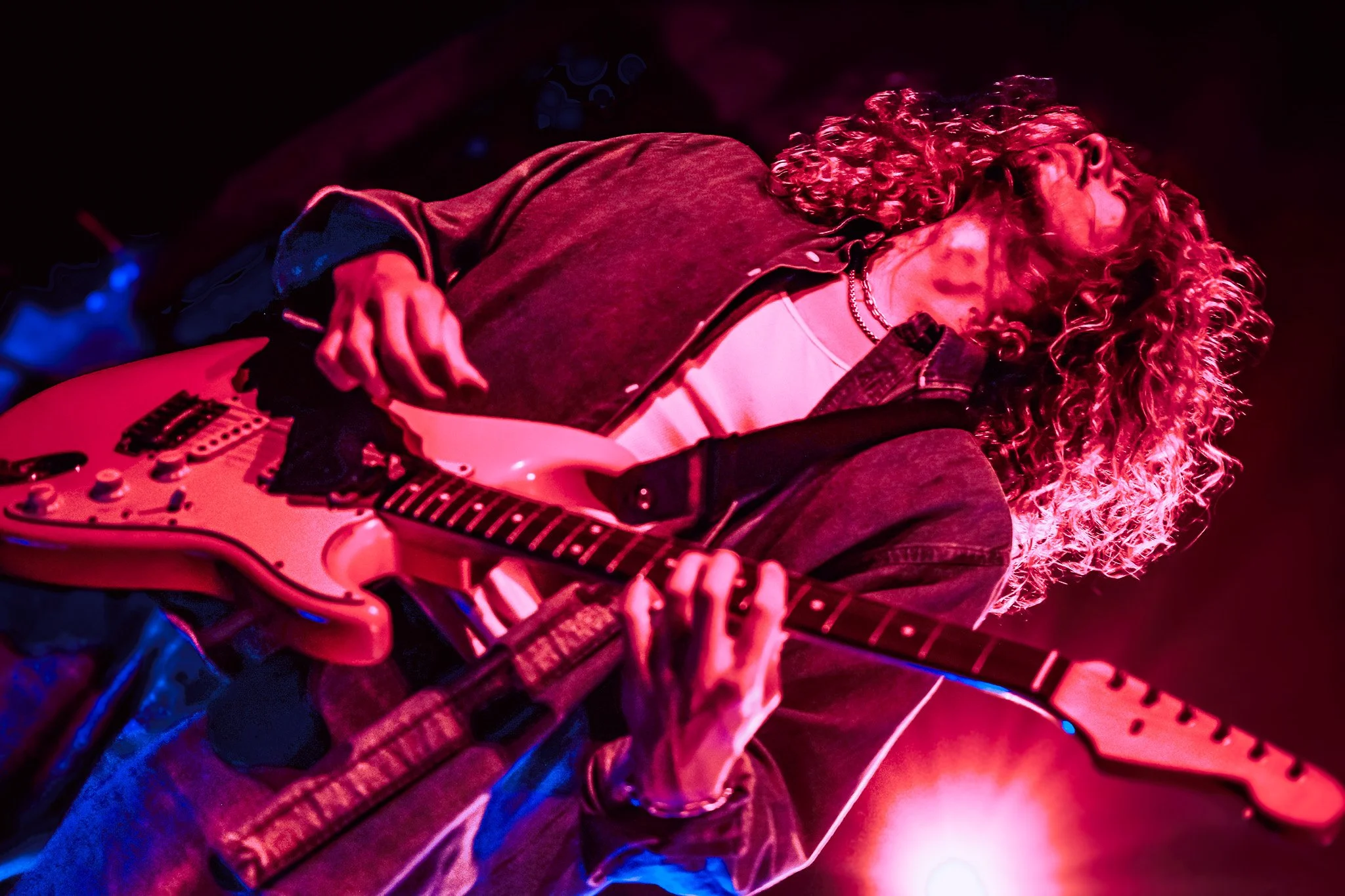  Contreras strums his guitar and flips his hair around as he energetically performs the upbeat song “Heaven.” 