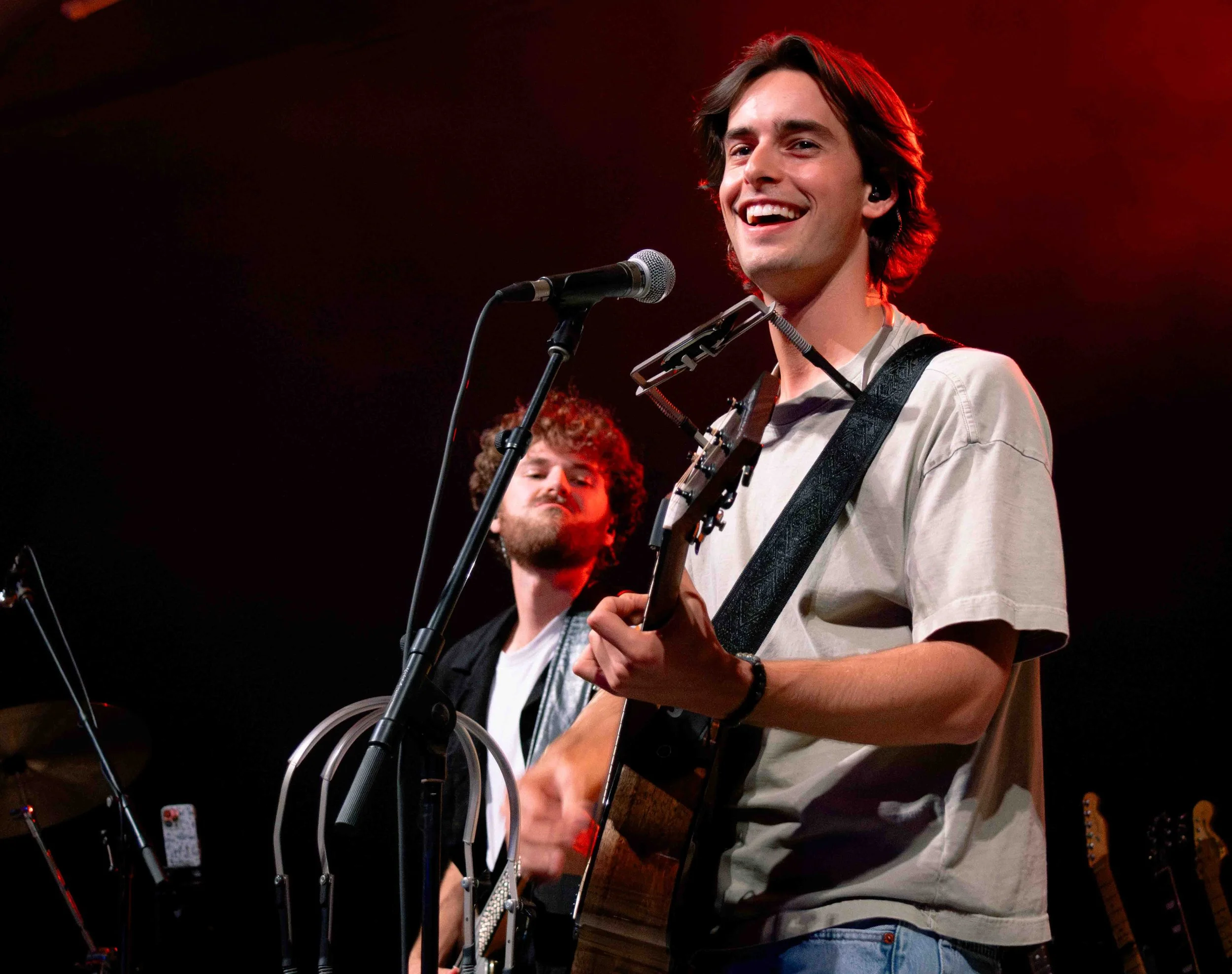  Noah Rinker smiles and plays the harmonica during country-folk song “Bleeding Heart.” 