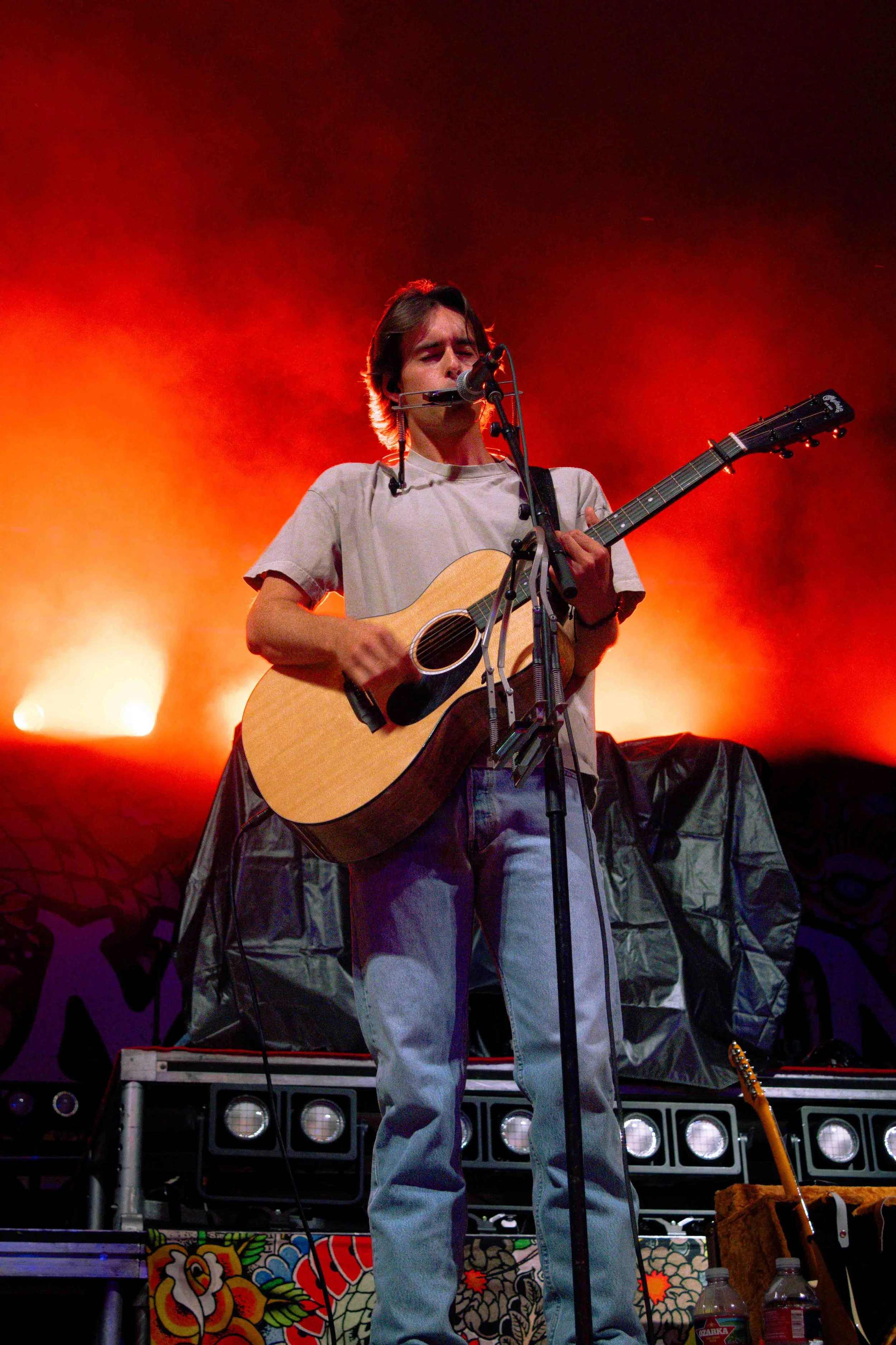  Noah Rinker smiles and plays the harmonica during country-folk song “Bleeding Heart.” 