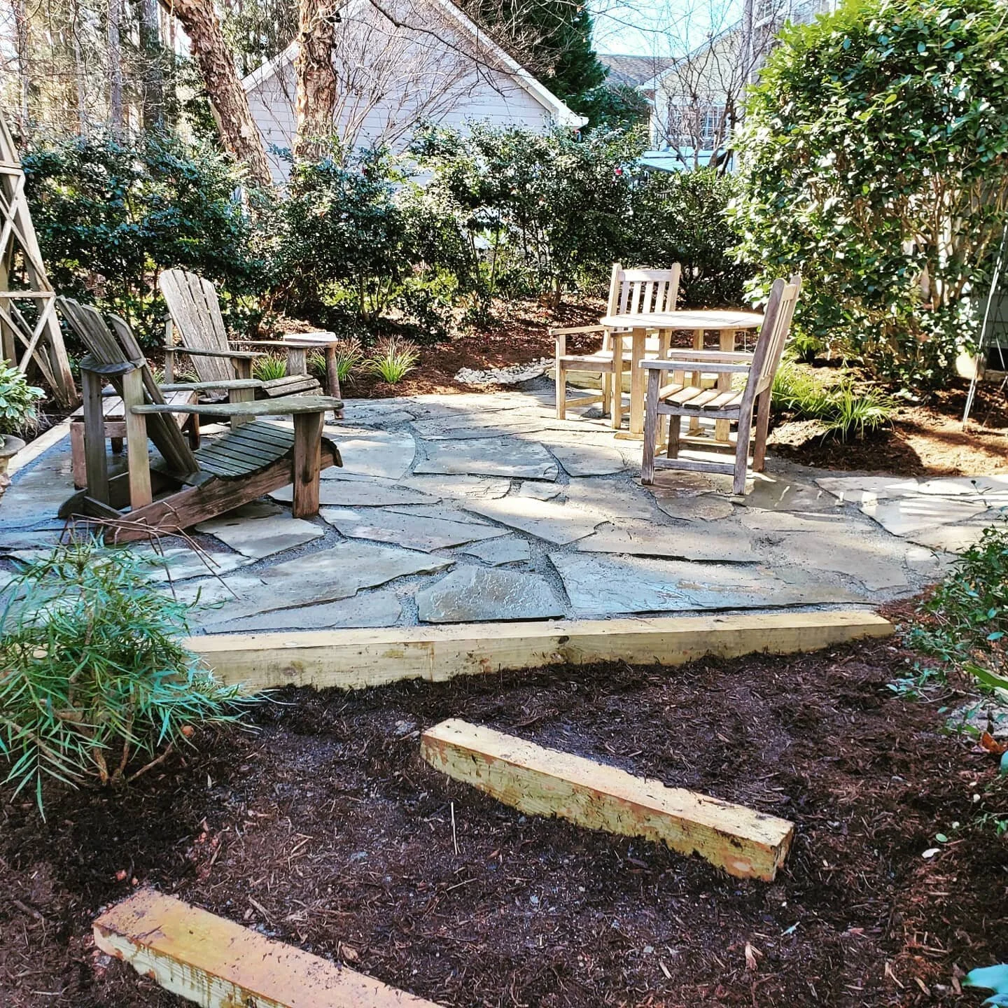 Flagstone paver patio on granite screenings #flagstonepatio #lumberretainingwall #landscapearchitecture #granitescreenings #backbreaker