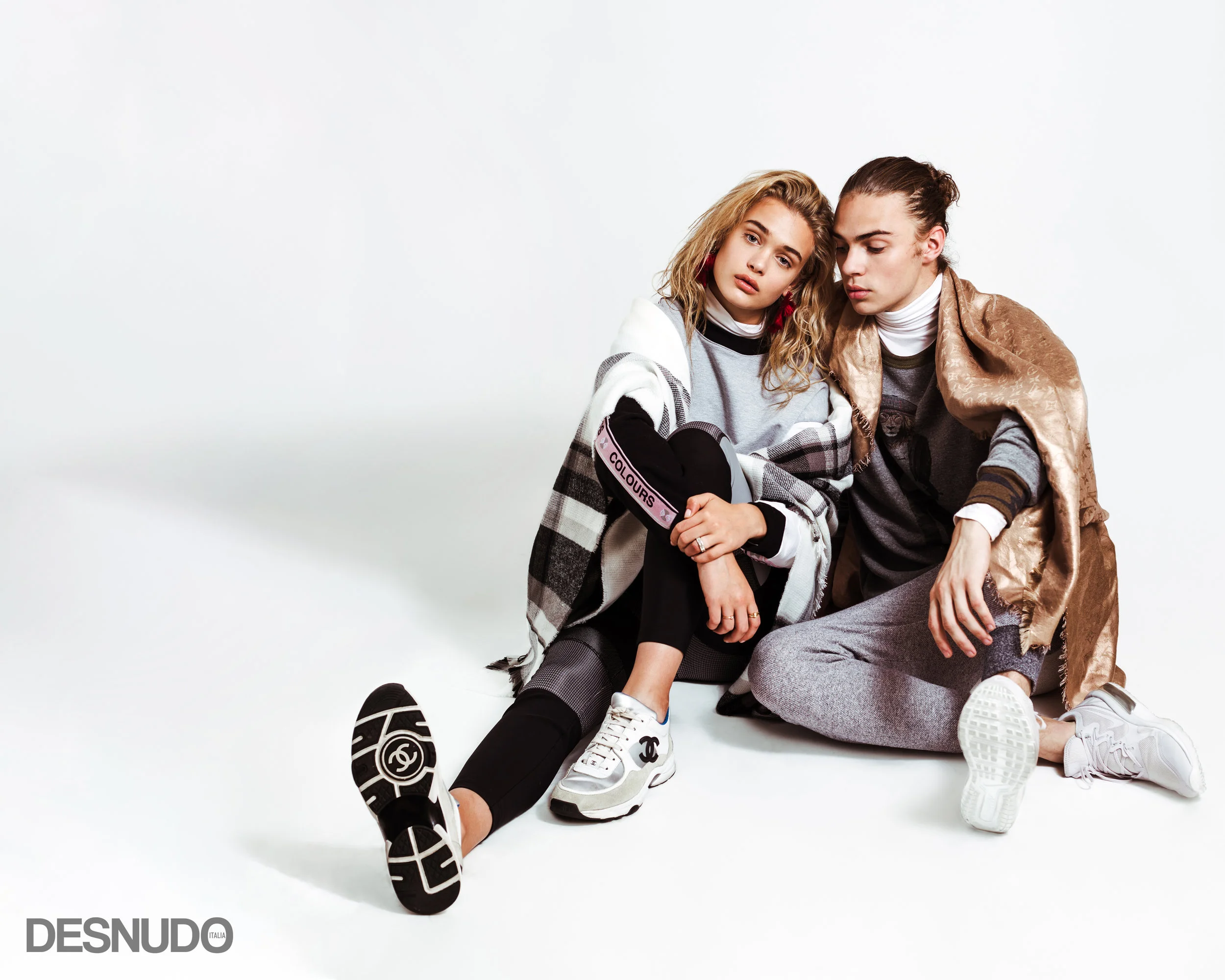 SPORTS FANATIC Athleisure is anything but casual with luxe hints of wool and cashmere. Take your loungewear from the sheets to the streets with pops of metallic and layered turtlenecks. Add your favorite logo sneakers or some artisanal earrings to really wake up this look. Carolina wears sweatshirt CROSS COLOURS , turtleneck LE CRUZ , leggings ALEXANDER WANG , sneakers CHANEL , scarf T&A SHOWROOM , earrings COBALT & TAWNY , rings MODEL’S OWN , Justin wears sweatshirt HERITAGE TRENDS , turtleneck LE CRUZ , sweatpants ARCHIVE , sneakers NIKE , scarf LOUIS VUITTON