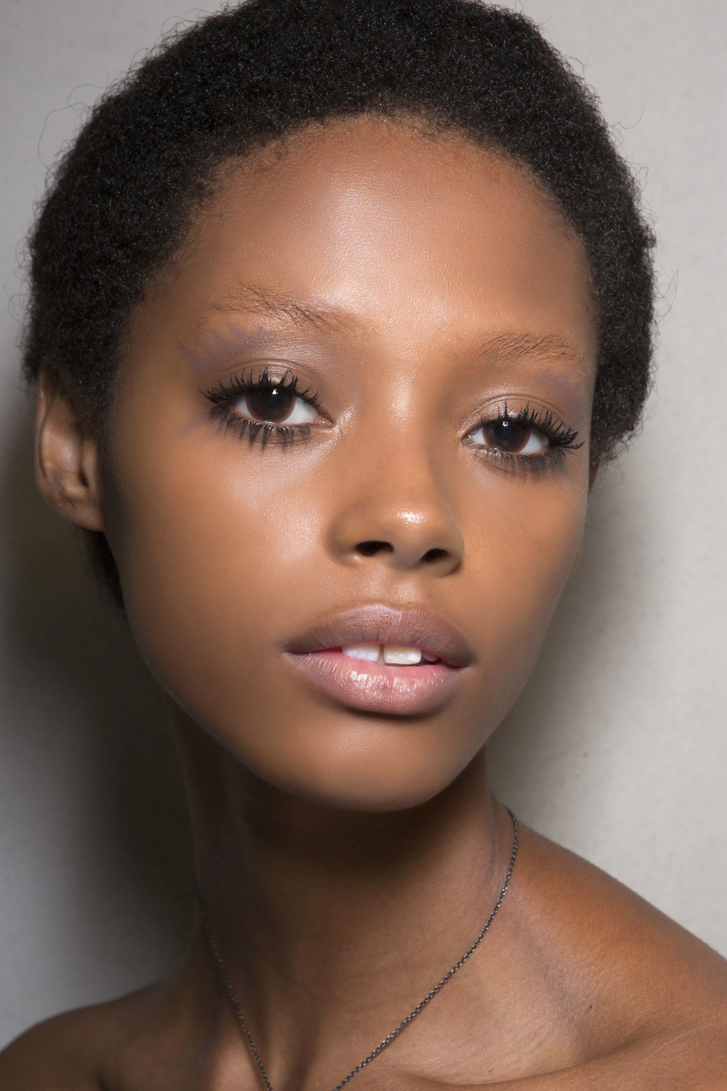 PRADA 60’s style look feathered eyeshadow, clumpy mascara bleached eyebrows and a matte nude lip. Look created by Pat McGrath.