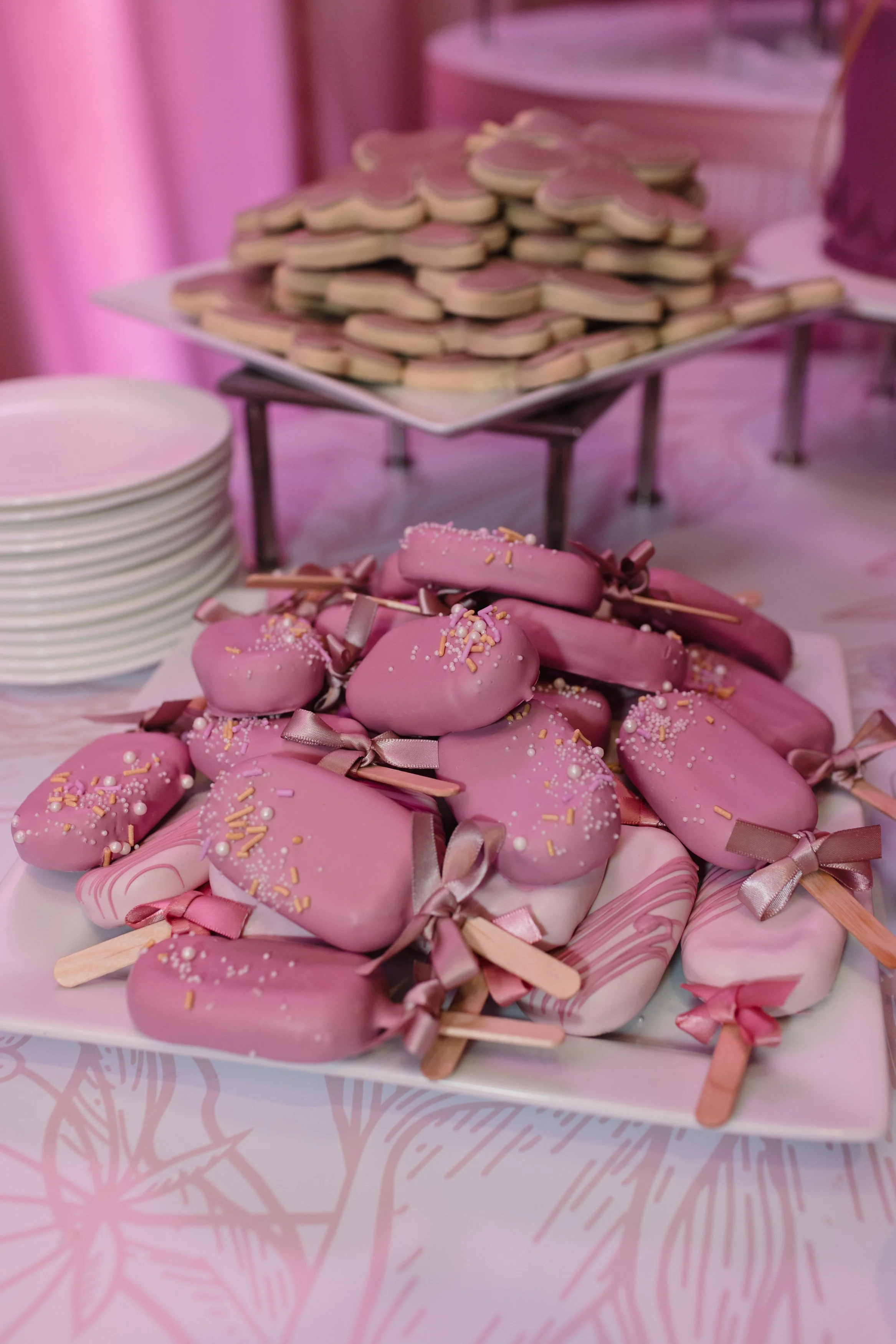 Luxury gluten free cakesicles with ribbons and bows.