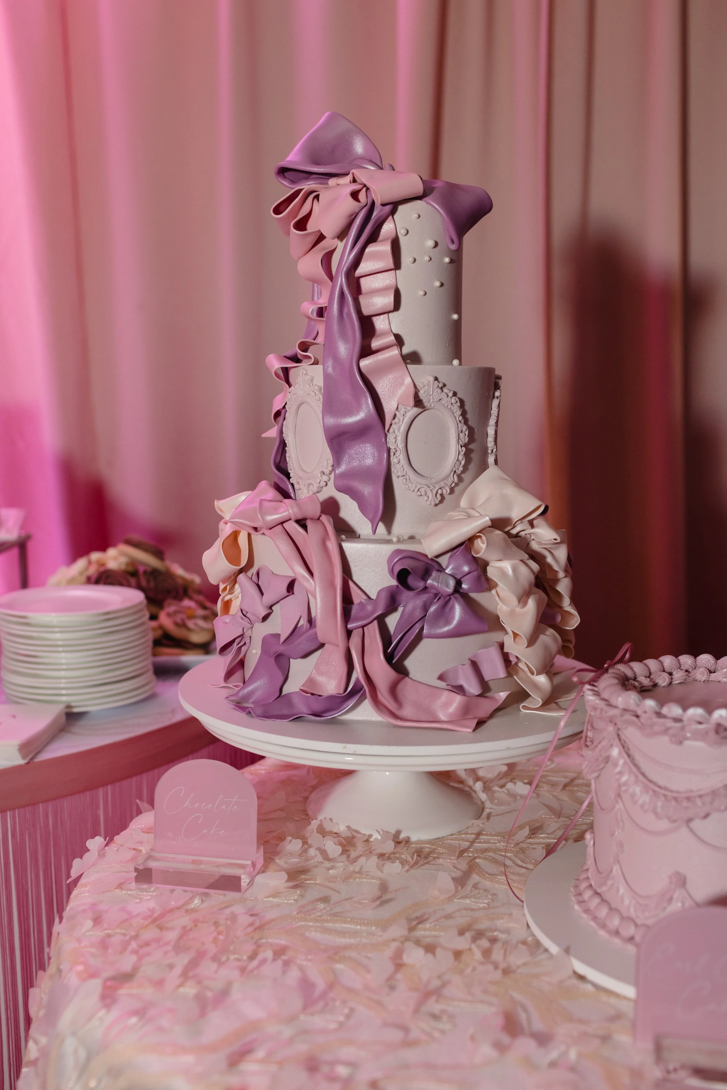 Luxury gluten free cake with hand tied and molded white chocolate ribbons and bows.