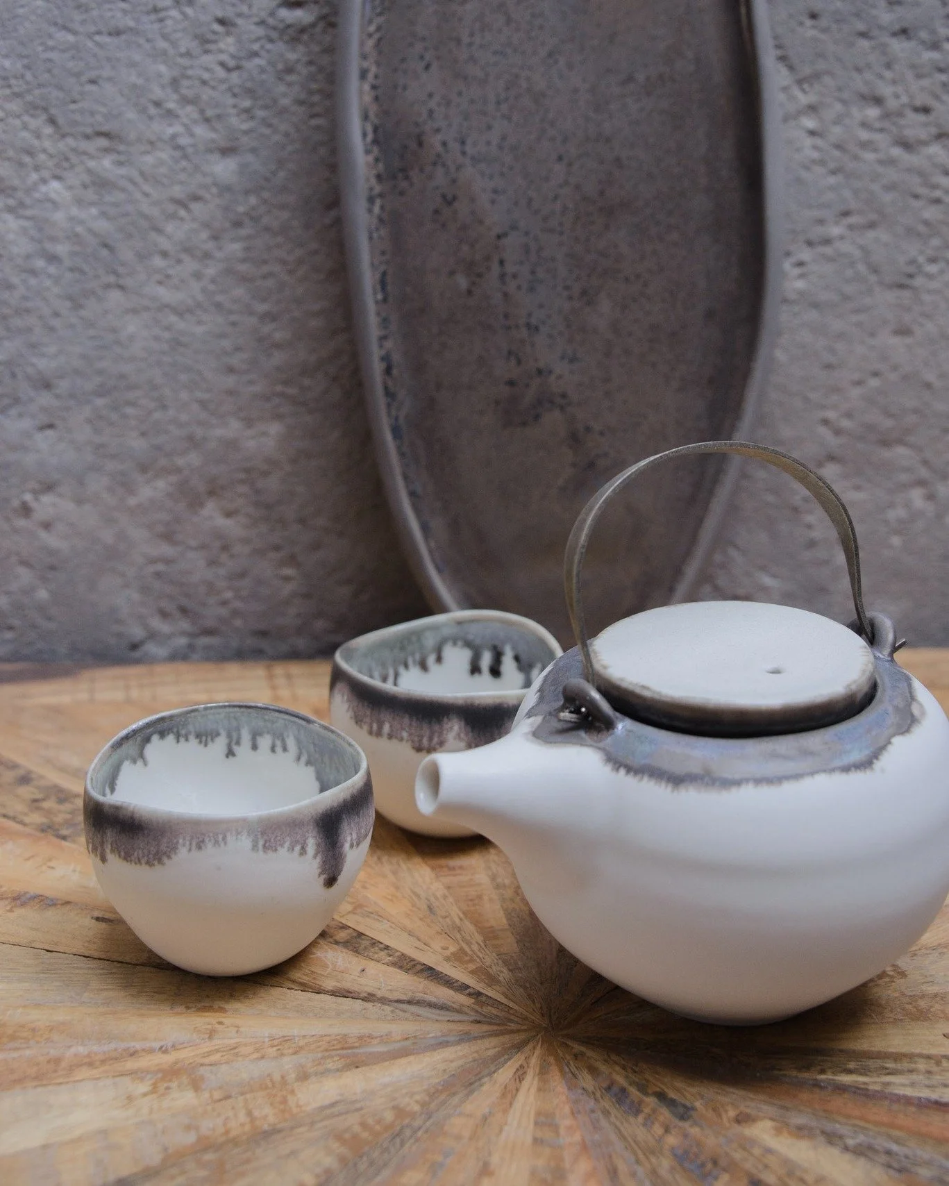 New wheel thrown Porcelain Teaset with bronze platter will be joining the next shop update.

The bronze glaze responds differently depending on the surface it meets.

On the glossy interior -  it becomes fluid, fracturing into tiny fern like branches