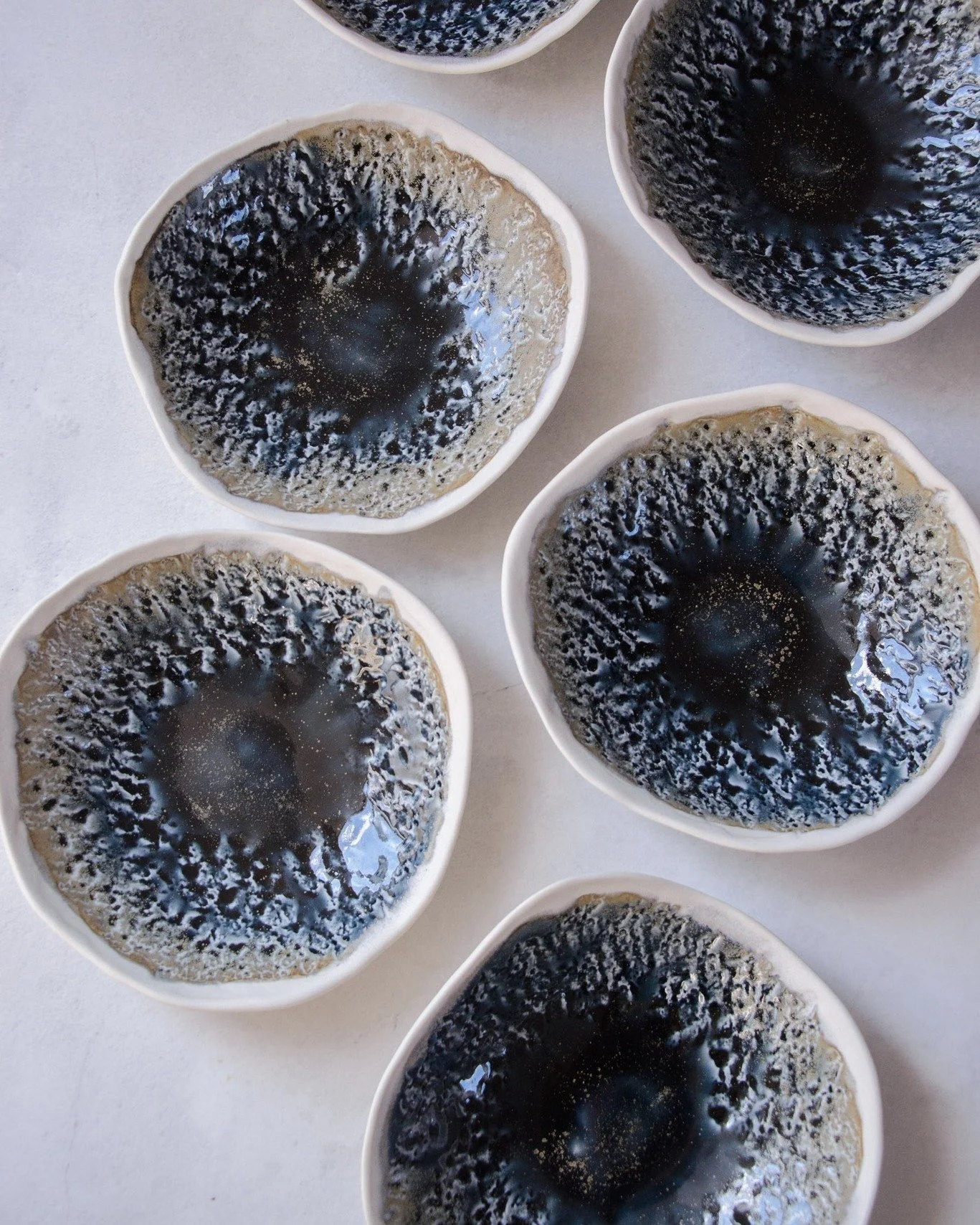 It does indeed sometimes takes years to find a way to best showcase a glaze.

Inside, these porcelain bowls feature our Galaxy glaze &mdash; this special-effect glaze evokes the depth of a night sky. Where the glaze gathers thicker, it pools into dee