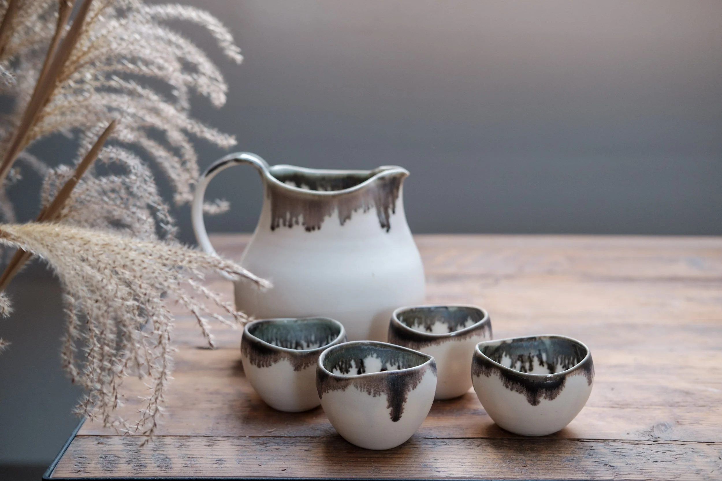 Wheel-thrown jug and cups