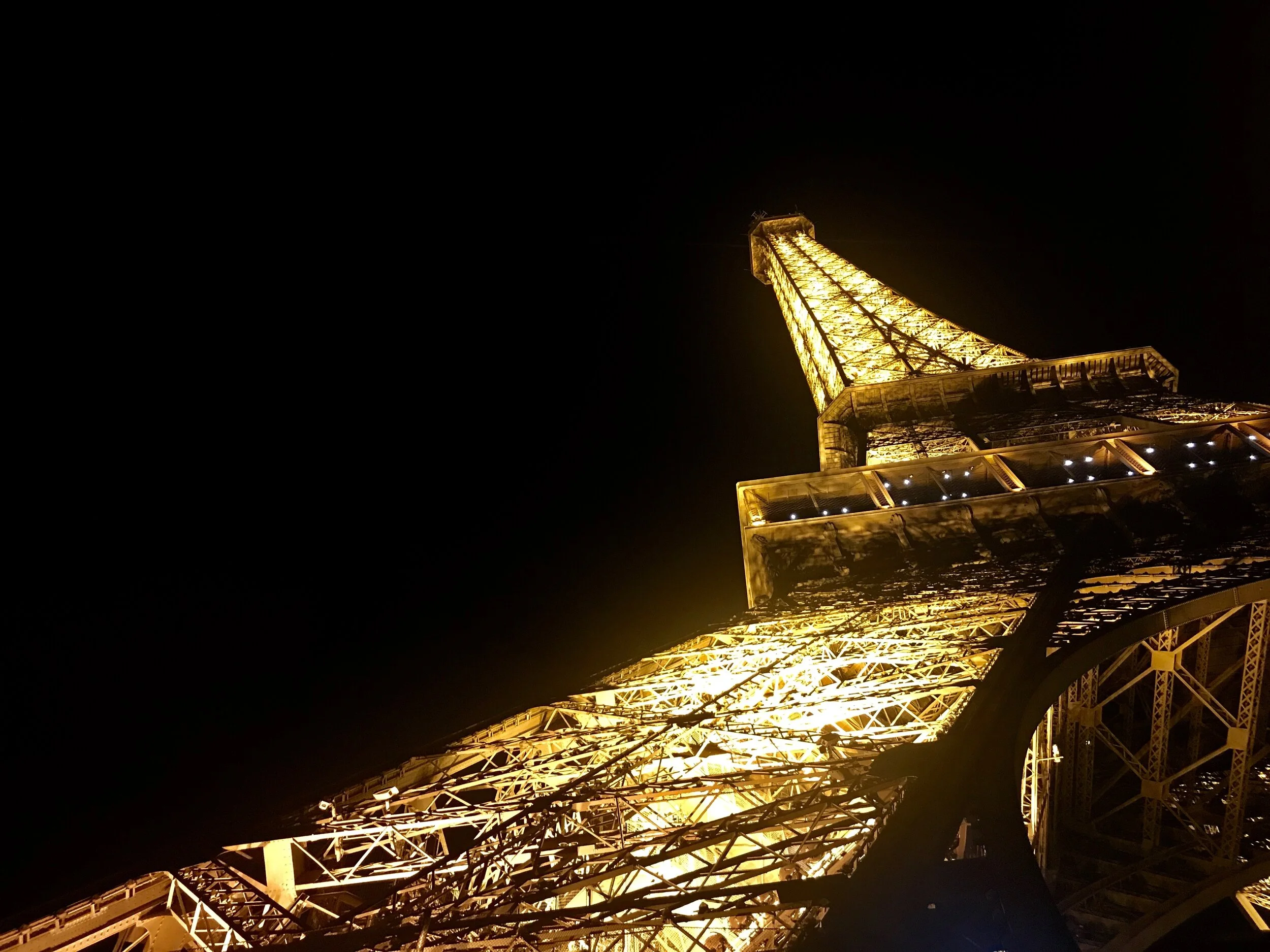 View of the Eiffel Tower in Paris, France lit up at night