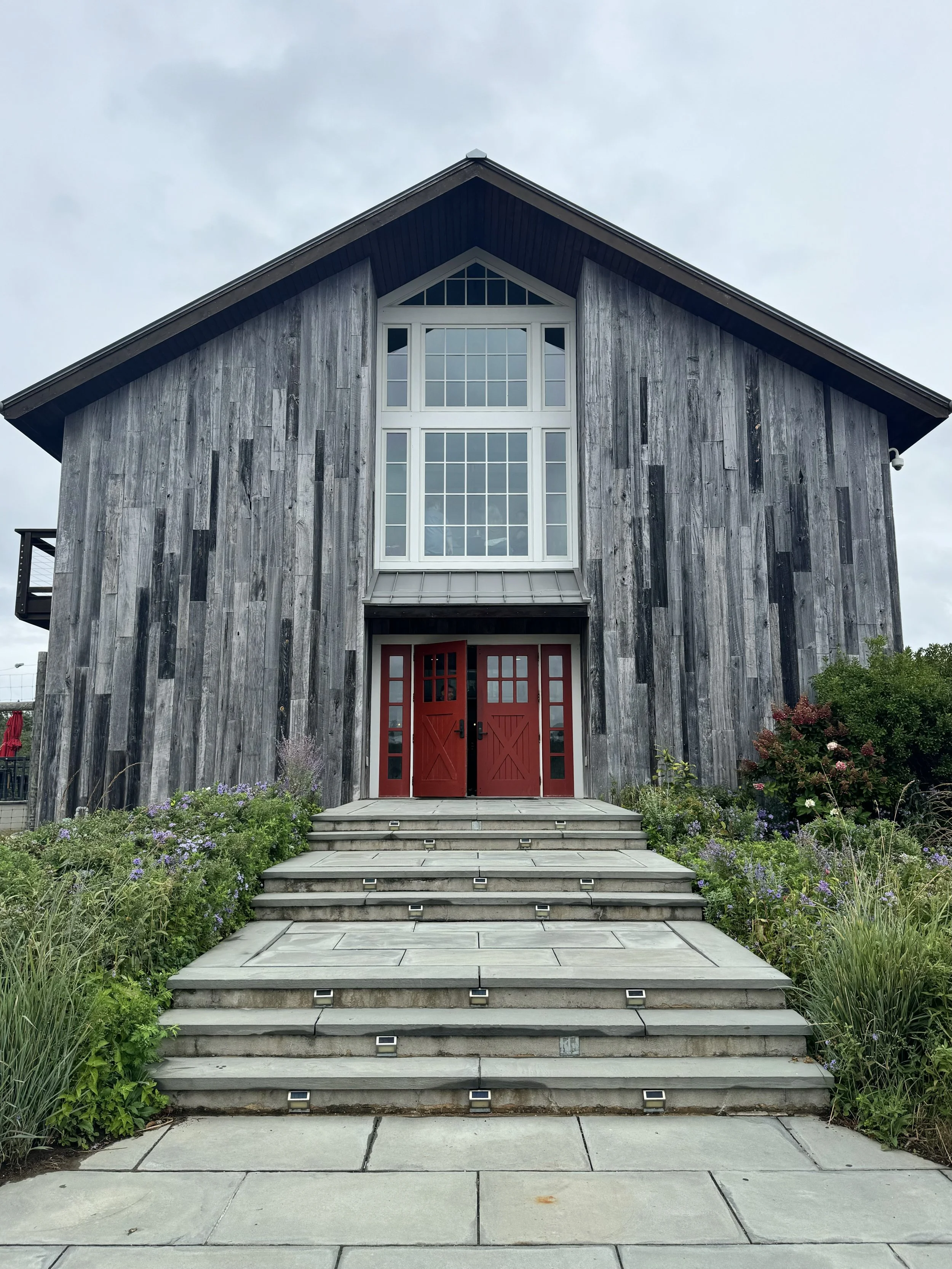 Kontokosta Winery's modern barn exterior with red door, Greenport, NY