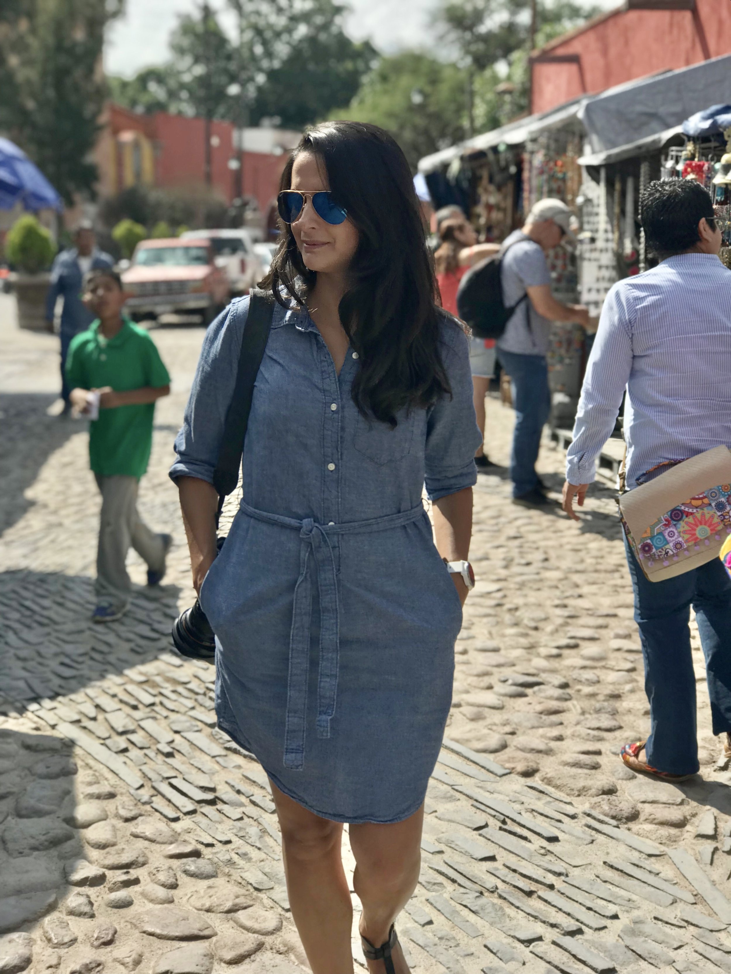 Karen Gomez, independent travel advisor and founder of Passport in Photos, walking through a market street