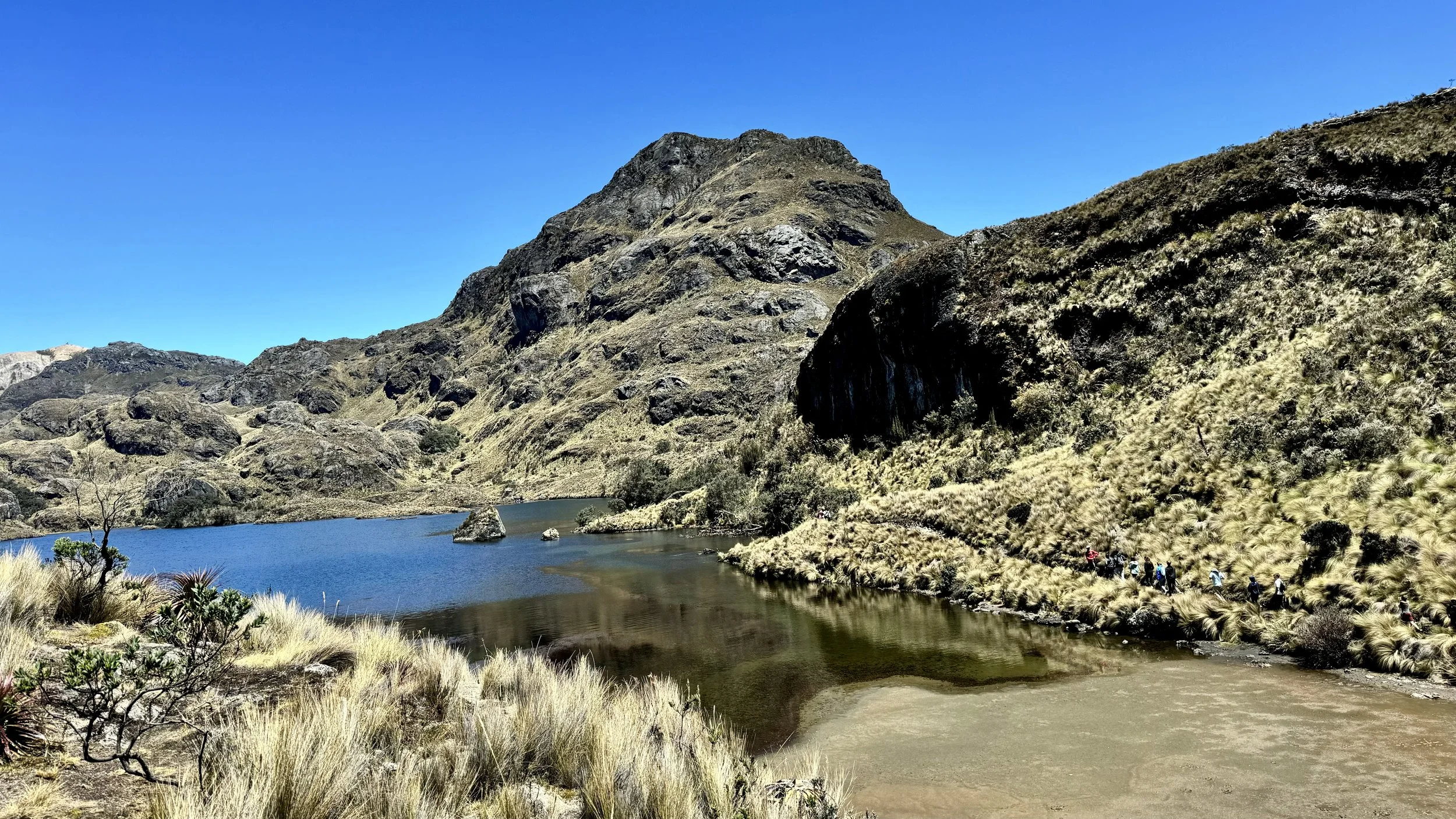 Laguna Toreadora with a dark mountain silhouette reflected in the still water