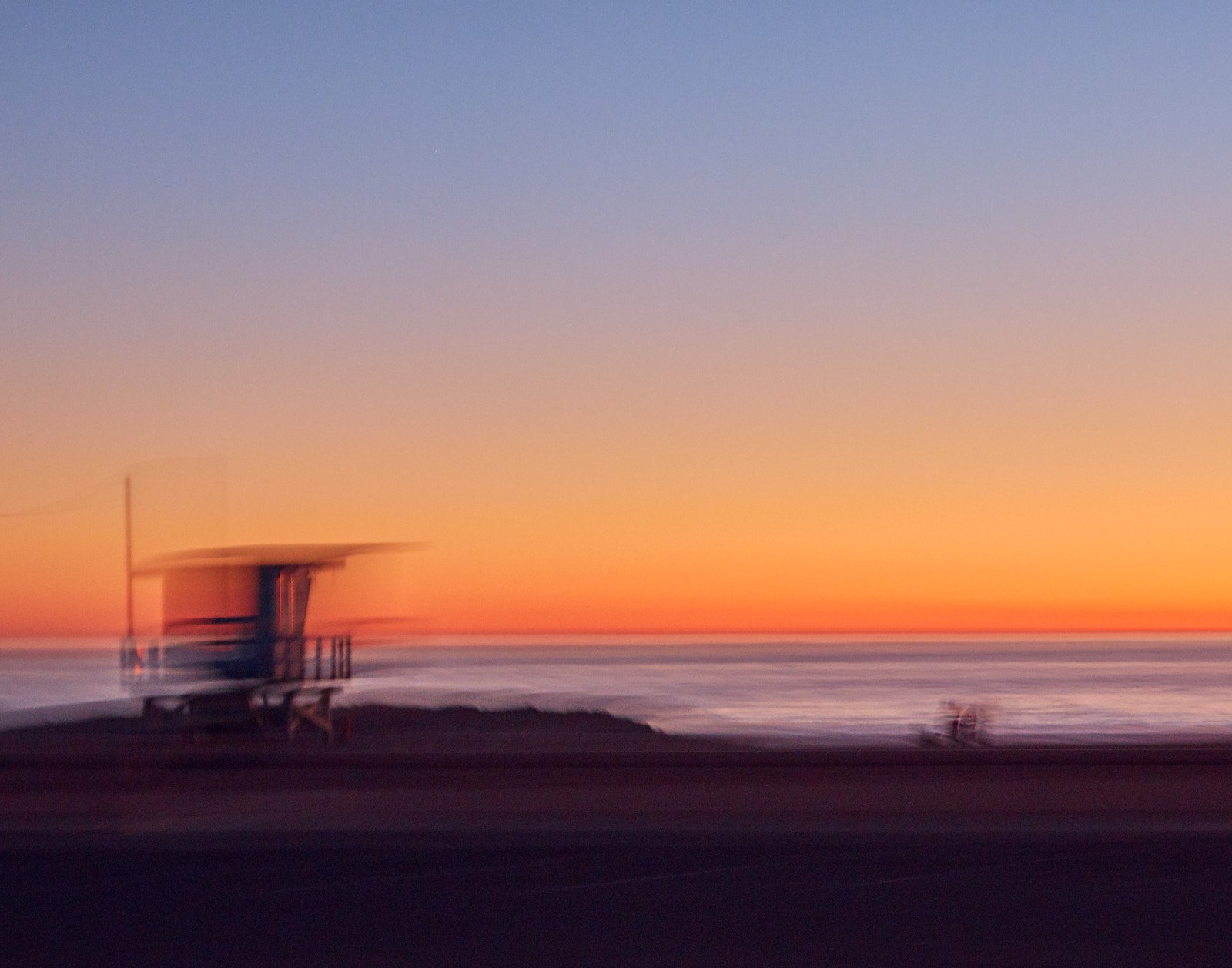 Lifeguard tower silhouette at sunset along the Pacific Coast Highway