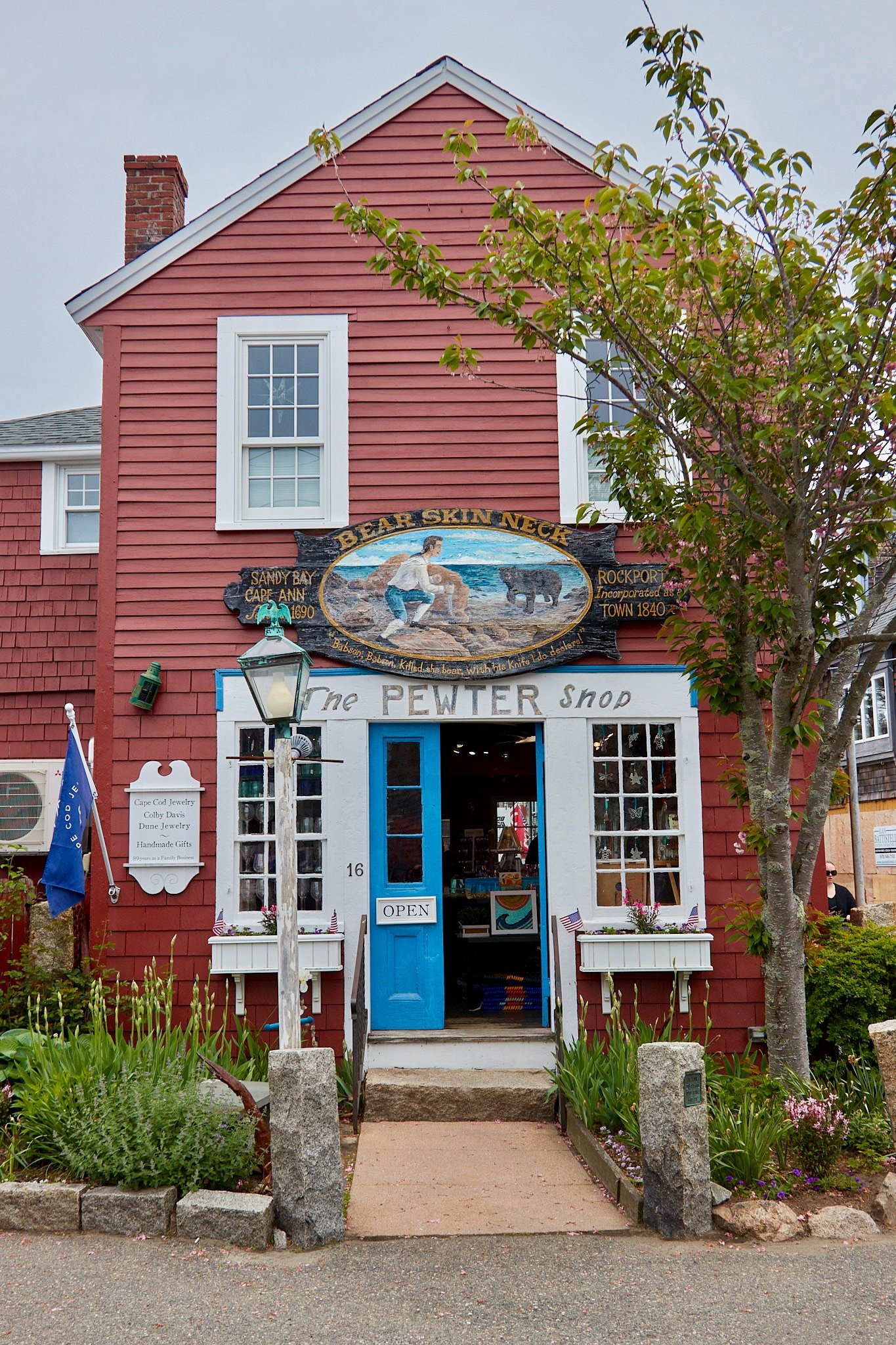The Pewter Shop storefront on Bearskin Neck in Rockport, Massachusetts, with the historic Bear Skin Neck sign above the entrance