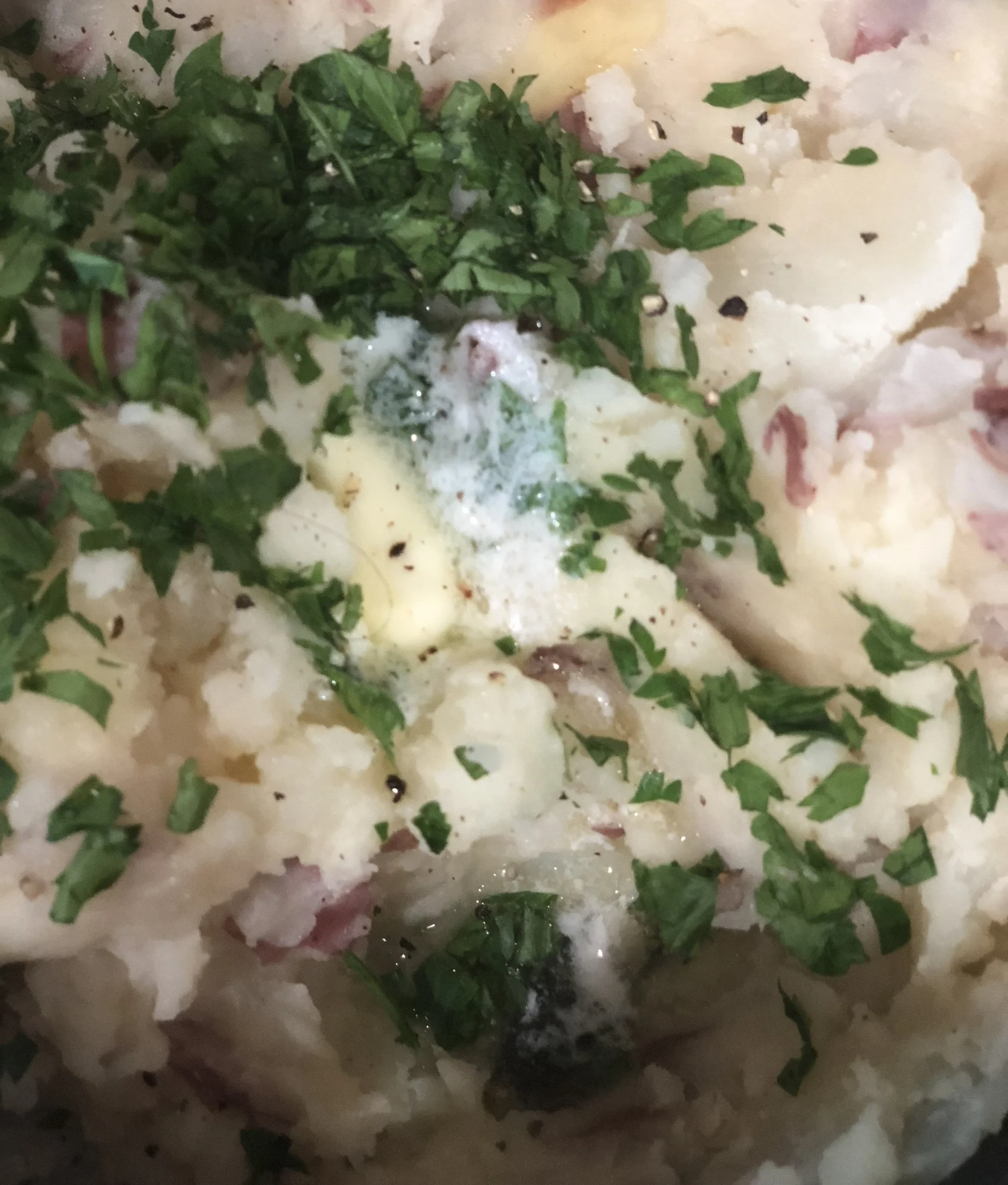 Parsley potatoes after the butter has melted and before the final stir.