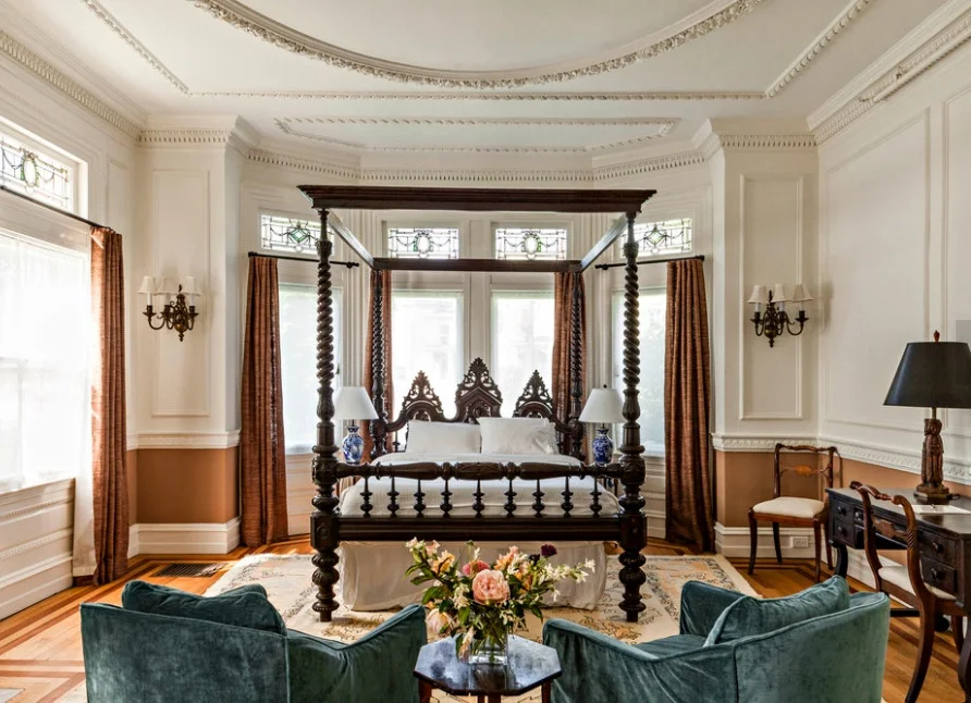 Pick a room… We chose the White Room on the ground floor of the mansion. Beside, crisp linens, a sitting area and a modernized bathroom, other features include trimmings of stained glass windows, gas fireplace with a marble mantel, and the focal point, a 19th century beautifully carved, black walnut, four-poster bed.
