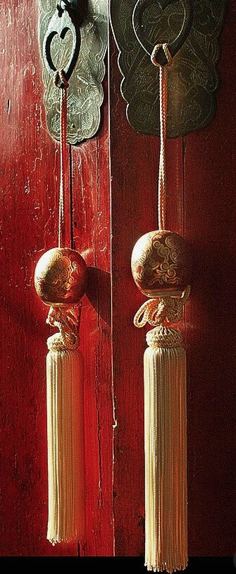 Chinese inspired tassels made with gold silk threads add that final touch to an already stunning door.