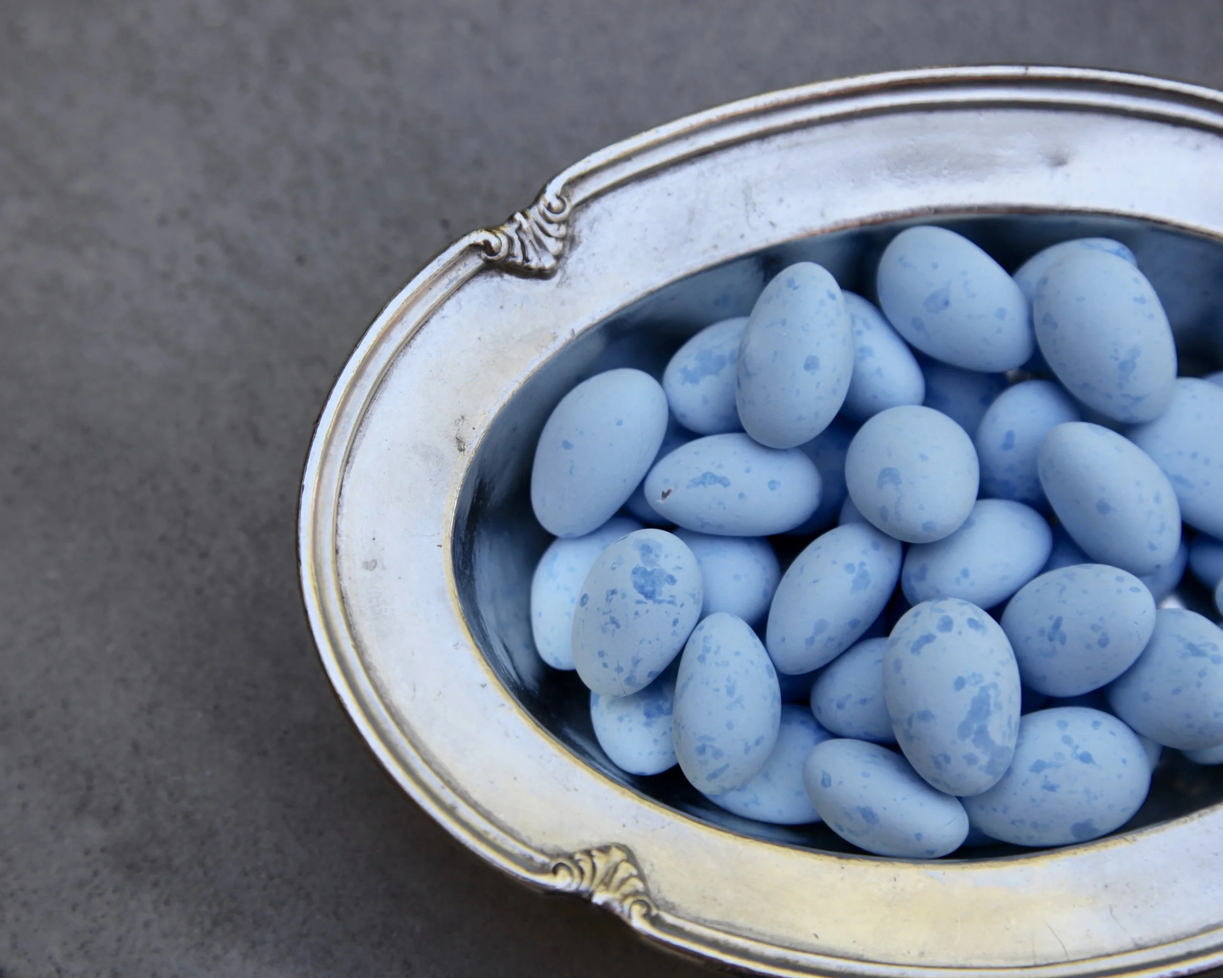 Robin egg blue caramels stand out in this vintage hotel silver candy dish.