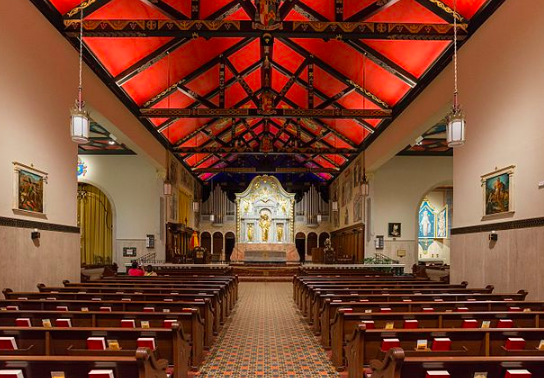 The brightly painted ceiling sets off the wood beams with their intricate drawings.