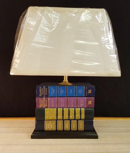 Reader's Digest Book Lamp This lamp was made from vintage reader's Digest Books. It stands 16-1/2" tall and includes a Rectangle Shaped Lampshade. Great lamp for any room, but a must for an avid reader or for that perfect reading area. Keep in mind, we can make lamps from your objects, and this includes your books. We commonly make lamps from old medical or law books that were used by the owner. We recently made a lamp from Harry Potter books that a client provided. $150.00, plus shipping