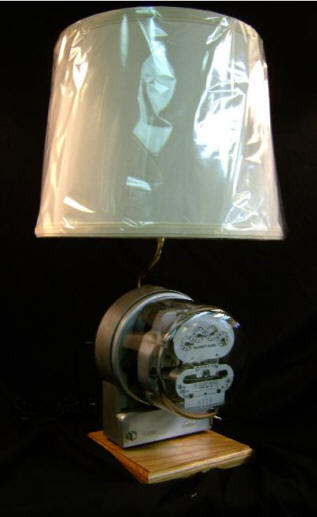 Duncan Electric Meter Lamp This Lamp is made from an Antique working electric meter. With the 3-way switch, you can see the speed of the dial increase as you switch the light bulb from low, to medium, to high. Designed with an Oak Wood Base. Really cool! Stands 21" tall, including the lampshade. $285.00, plus shipping