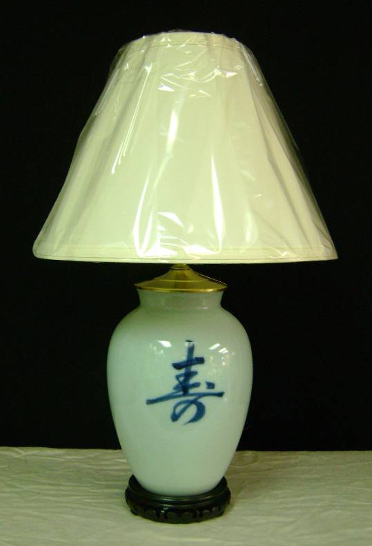 Chinese Symbol Vase Lamp Simple design... Blue Oriental Symbol painted on a light-blue porcelain vase. Stands 21" high. Shown with a #509 Parchment Linen lampshade. $150.00 complete, plus shipping