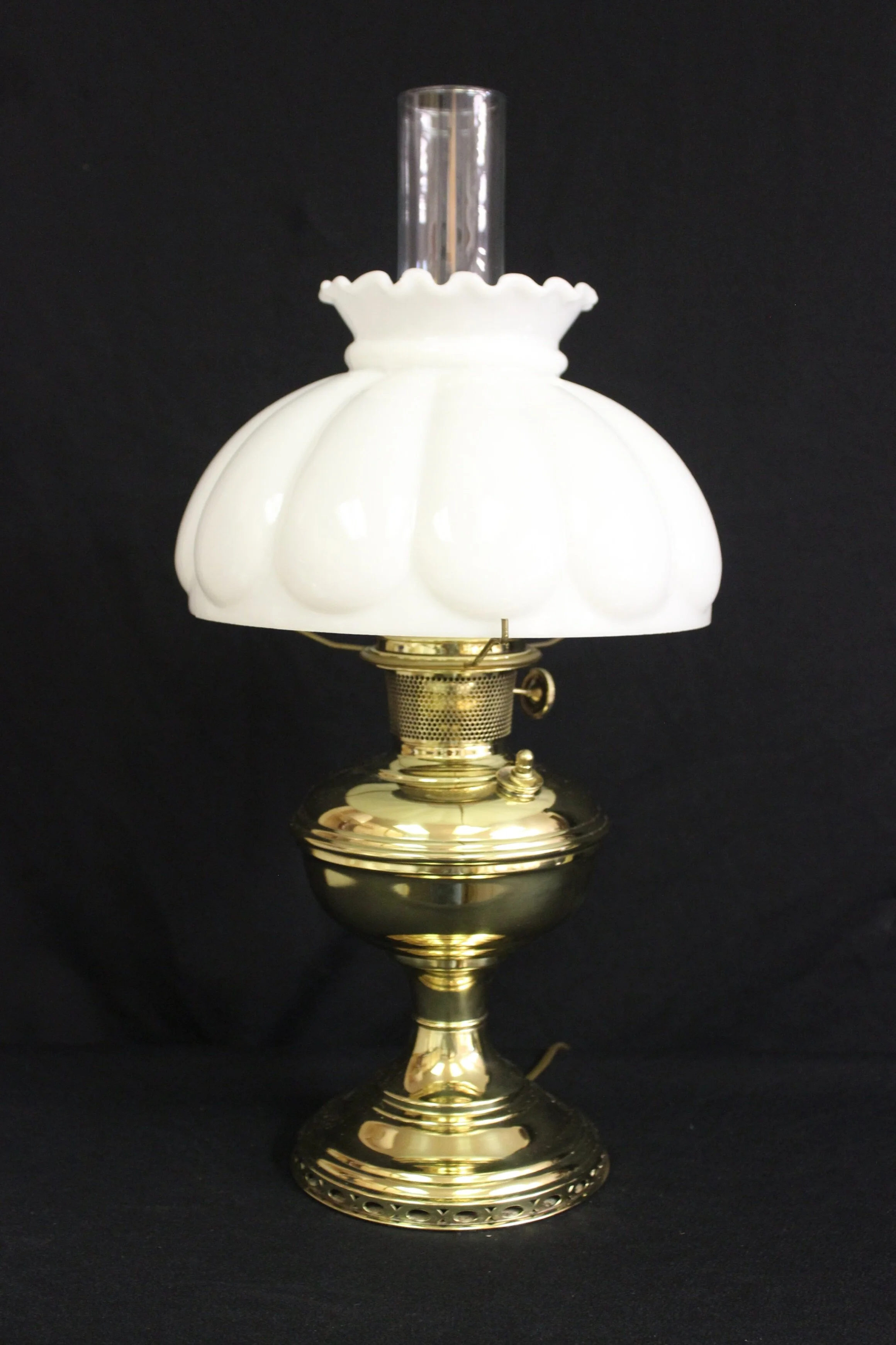 Original Aladdin Model #9 Brass Lamp. This lamp was originally a kerosene lamp, and was made by Aladdin from 1920-1922. The restoration work includes: Electrifying, Polish & Lacquer, New glass chimney and new 10 Opal Glass shade (Shade made in the US). The lamp is wired with high quality electrical components. Gold colored lamp wire extending approximately 7 feet from the wood base to the plug. This lamp stands 21" high. $295.00, plus shipping
