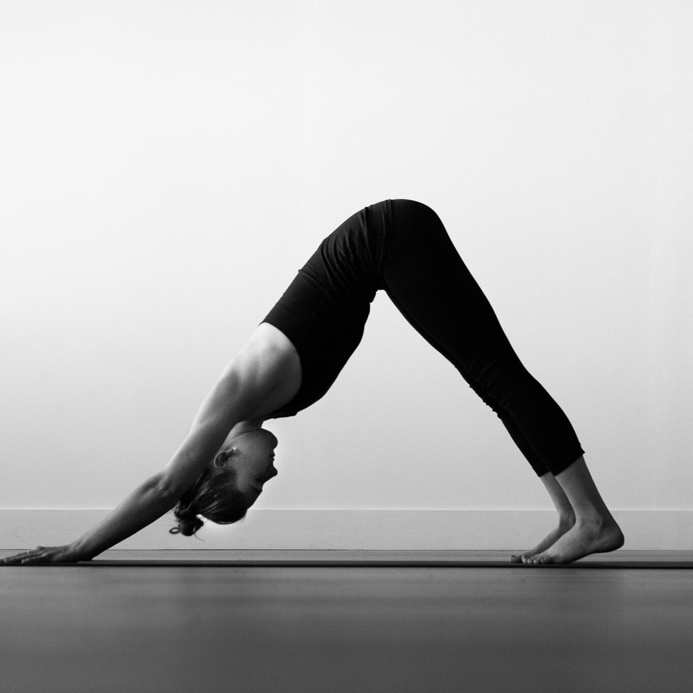 woman practising downdog in yoga
