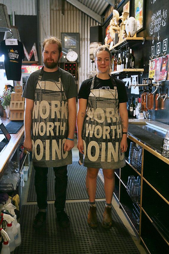 Kay Abude WORK WORTH DOING 22 - 31 March 2019 Hand silk screen on linen sewn into garments and performed by staff at Shedshaker Brewery and Taproom for the Castlemaine State Festival 2019 Dimensions variable