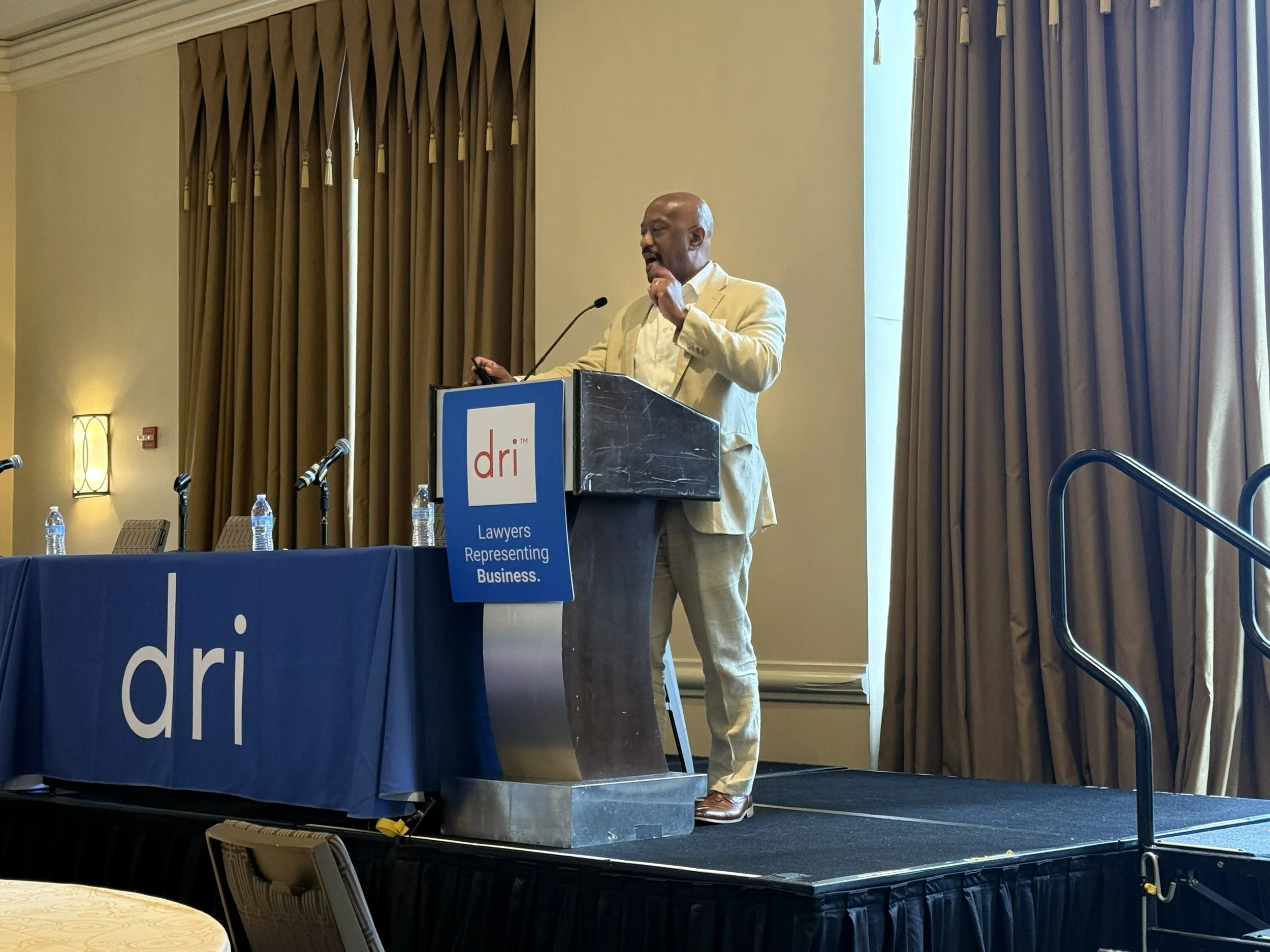 Sean C. Griffin speaking on litigation and artificial intelligence at a conference.