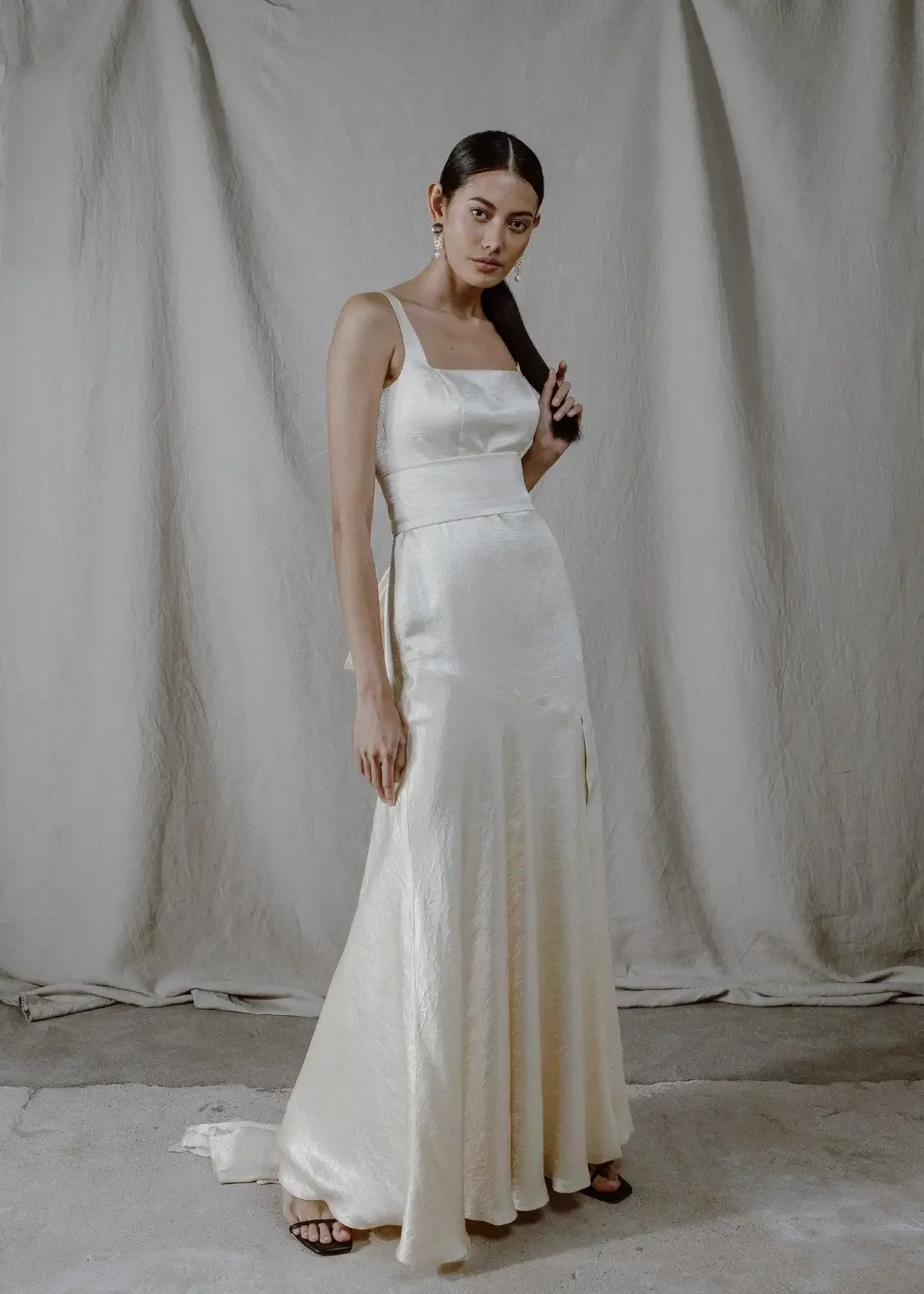 Kiiltävästä Naia-selluloosakuidusta valmistettu Zafra-hääpuku. Kuvassa näkyy satiinin kaunis lankeemus ja puvun ylellinen norsunluunvalkoinen sävy.