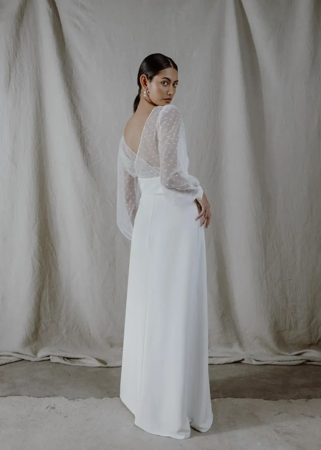 Valkoinen Fiore-hääpuku: lyhyt pitsinen yläosa ja korkeavyötäröinen pitkä hame. Ateljeevalmisteinen kotimainen hääpuku