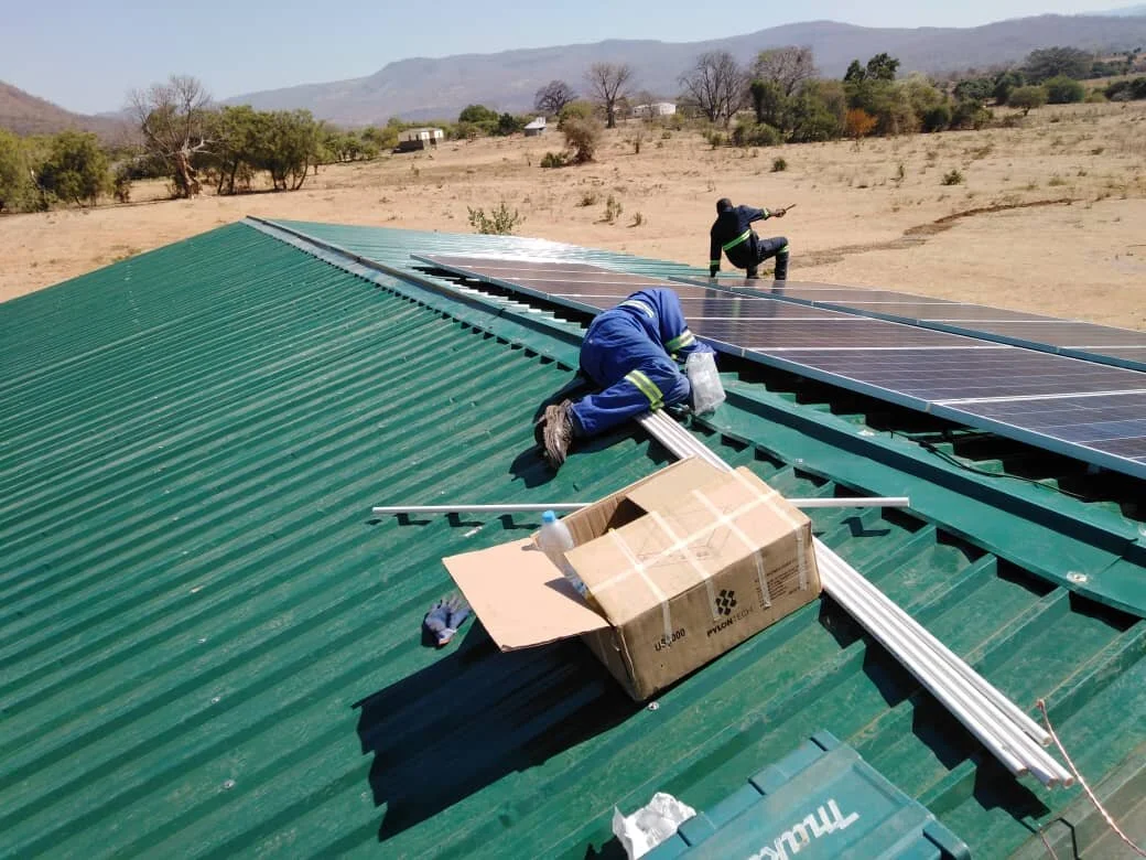 Installing solar panels at Sianyolo