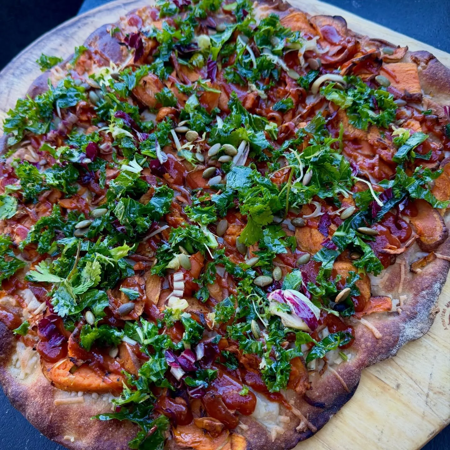 WINTER MENU FAVE
Here&rsquo;s another look at our new BBQ SWEET POTATO PIZZA!  Thinly-sliced sweet potatoes, leeks, v-mozz, ginger bbq sauce, cilantro, pumpkin seed, and dark greens on our slow-fermented multigrain pinsa crust. Mmmm yes please! 🍕⚡️?