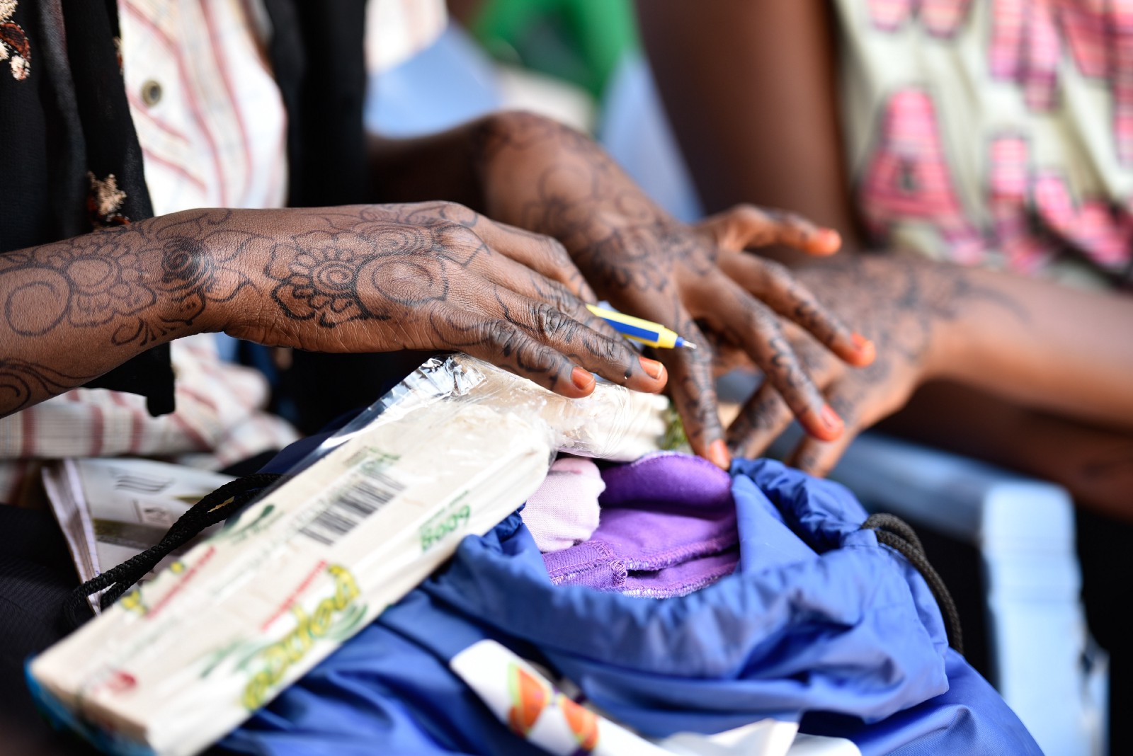 A young woman perusing her ‘Huru Kit’ containing reusable sanitary pads