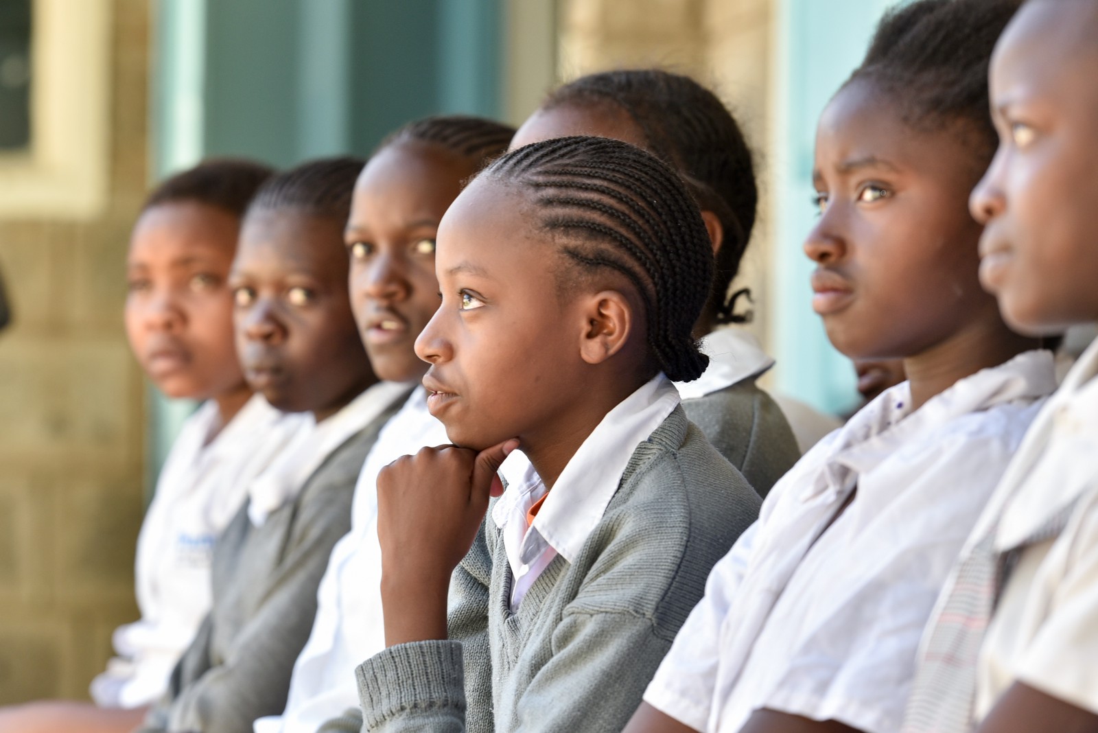 A female student watches intently during a Huru Educational Seminar
