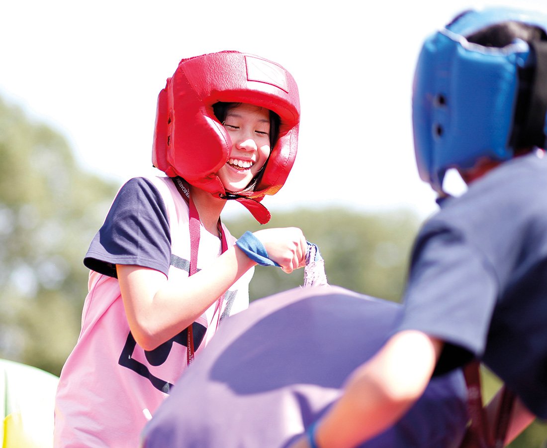 Female Student Smiling at Camp Dragon Playing with Inflatables.jpg