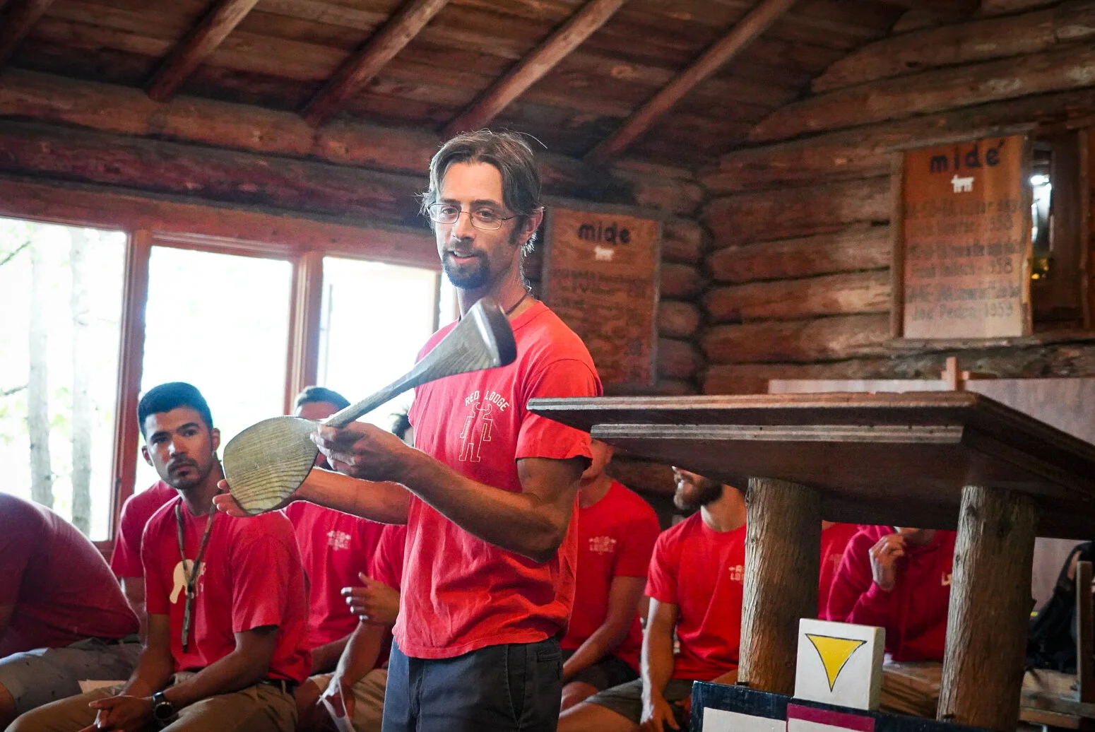 Alex Ernst holds his beavertail paddle during a Red Lodge church service. (Kate Downey)